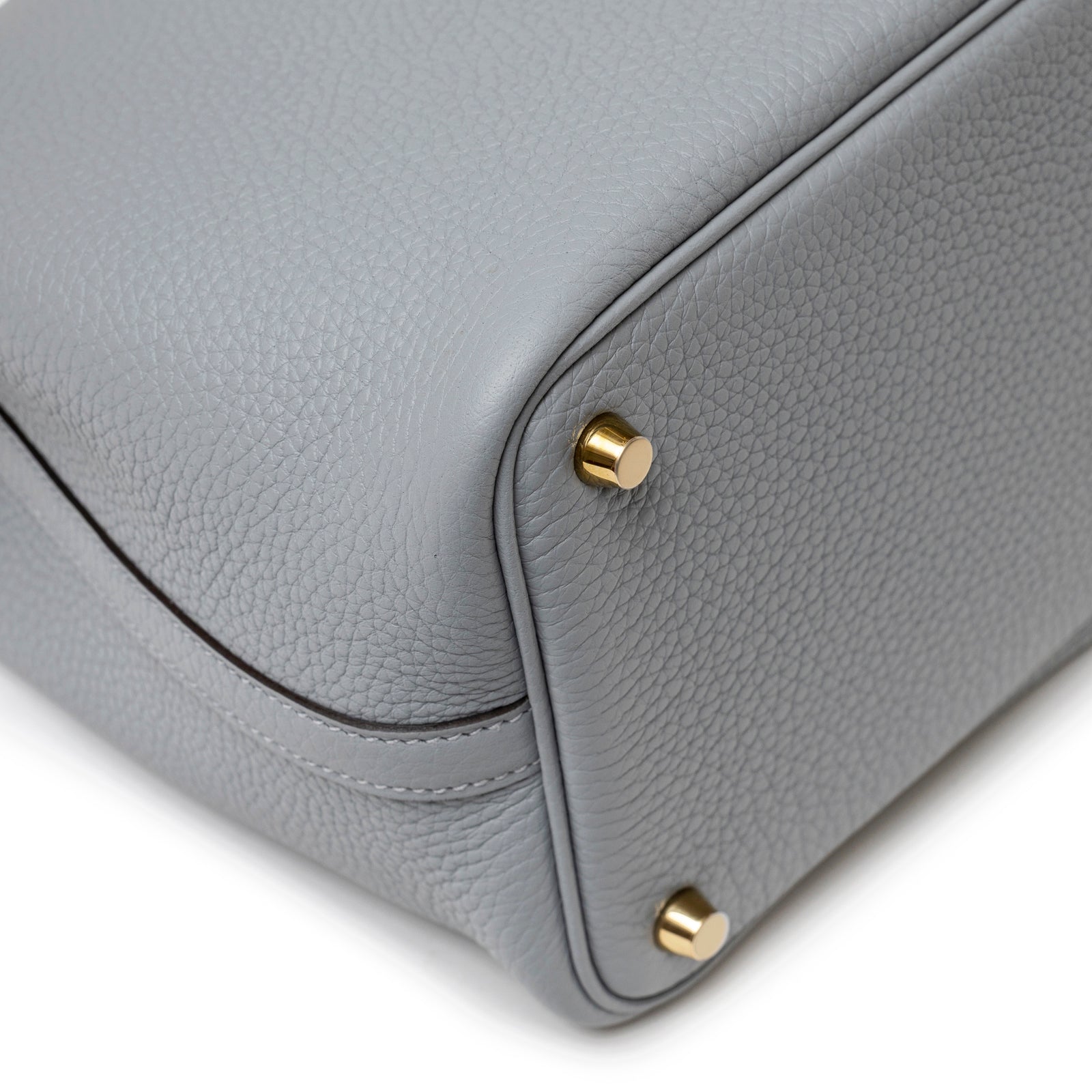Close-up of bottom corner on Hermès Picotin 18 Gris Pantin Clemence Gold Hardware gold feet