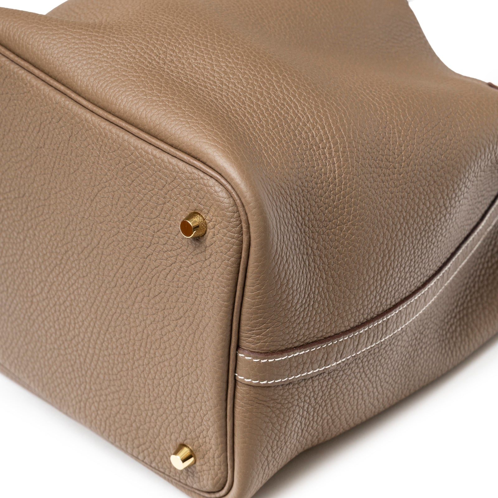 Close-up of Hermès Picotin 22 Etoupe Clemence Gold Hardware corner showing textured leather and gold feet