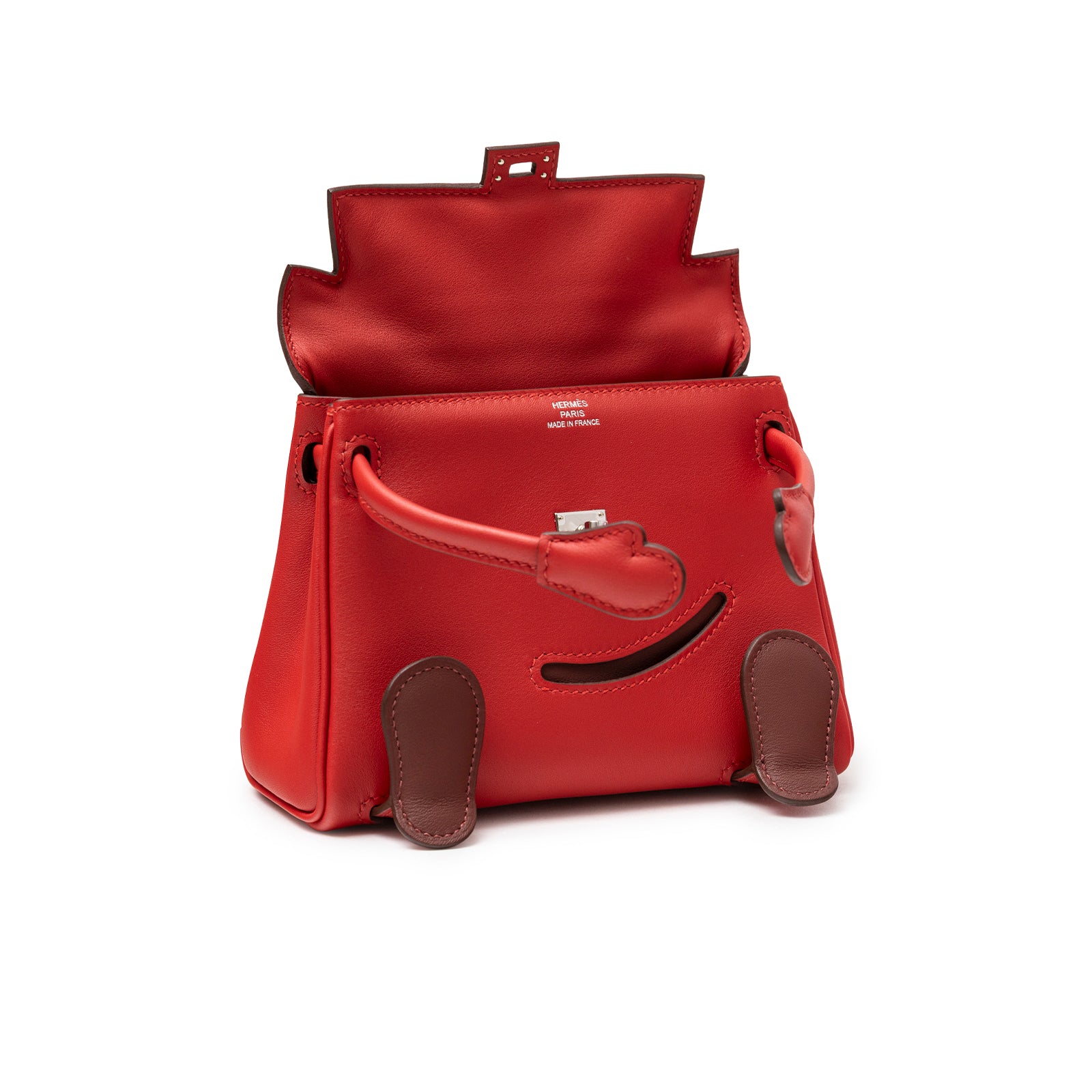 Angled open view of Hermès Quelle Idolle Kelly Doll Rouge Radieux Rouge H Swift Palladium Hardware showing interior and vibrant red leather.