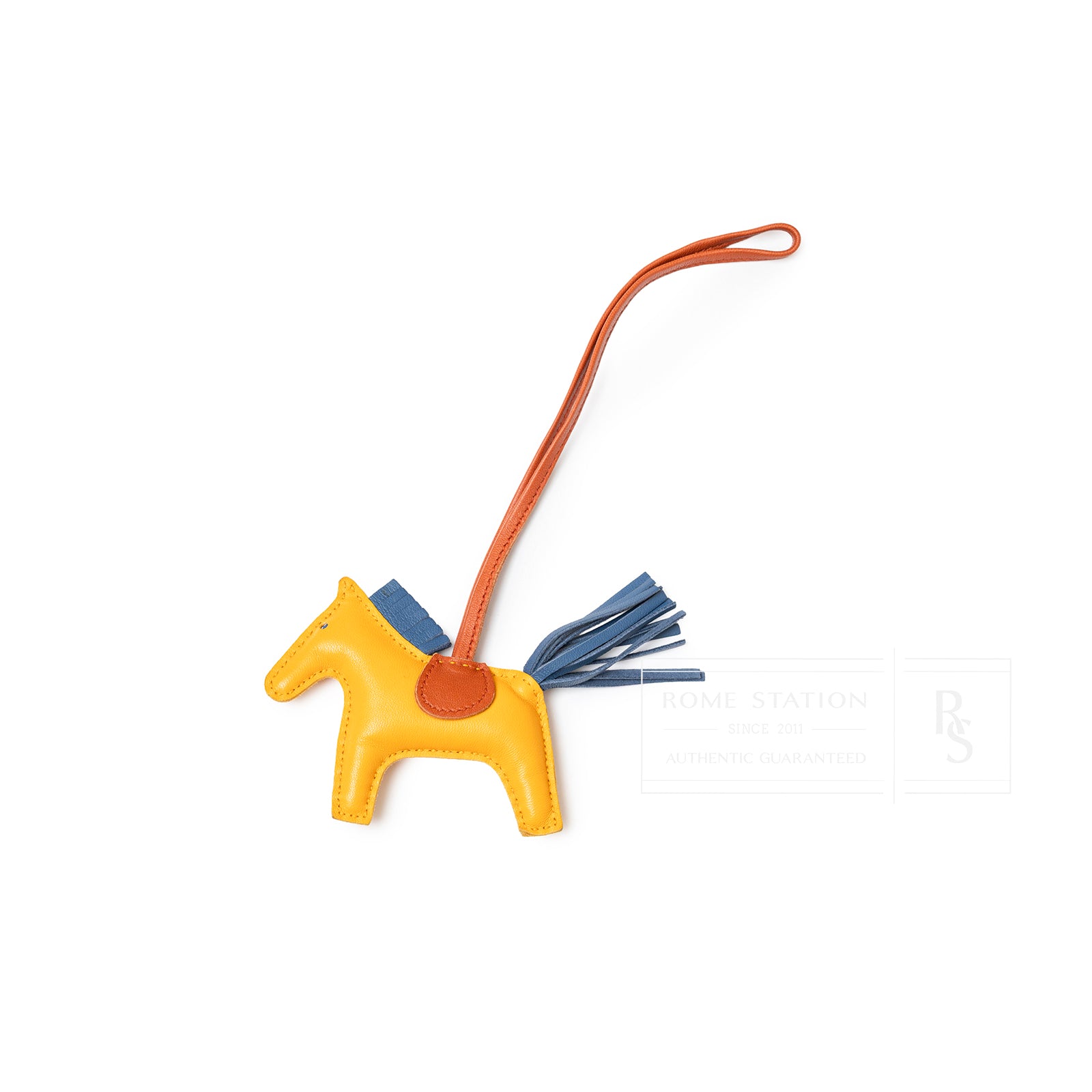 Top-down view of Hermès Rodeo PM Jaune D'or/Blue Agate/Cornaline leather horse charm with orange strap