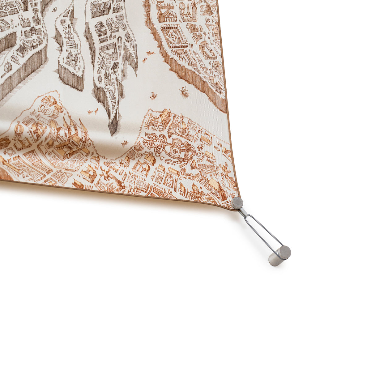 Close-up of Hermès Scarf Display System corner holding a Hermès Scarf on the wall