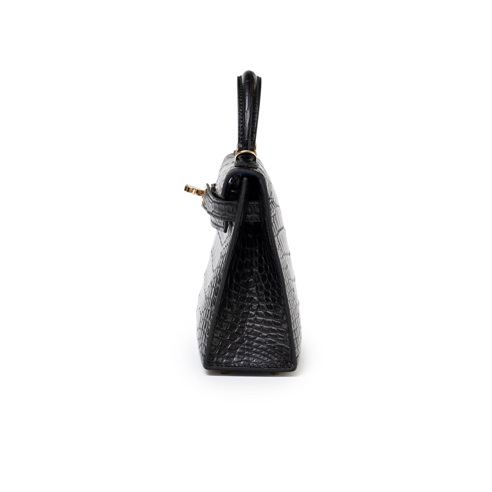 Side profile of Hermès Horseshoe Mini Kelly II Black/Blue Matte Alligator Permabrass Hardware bag showing textured leather and handle