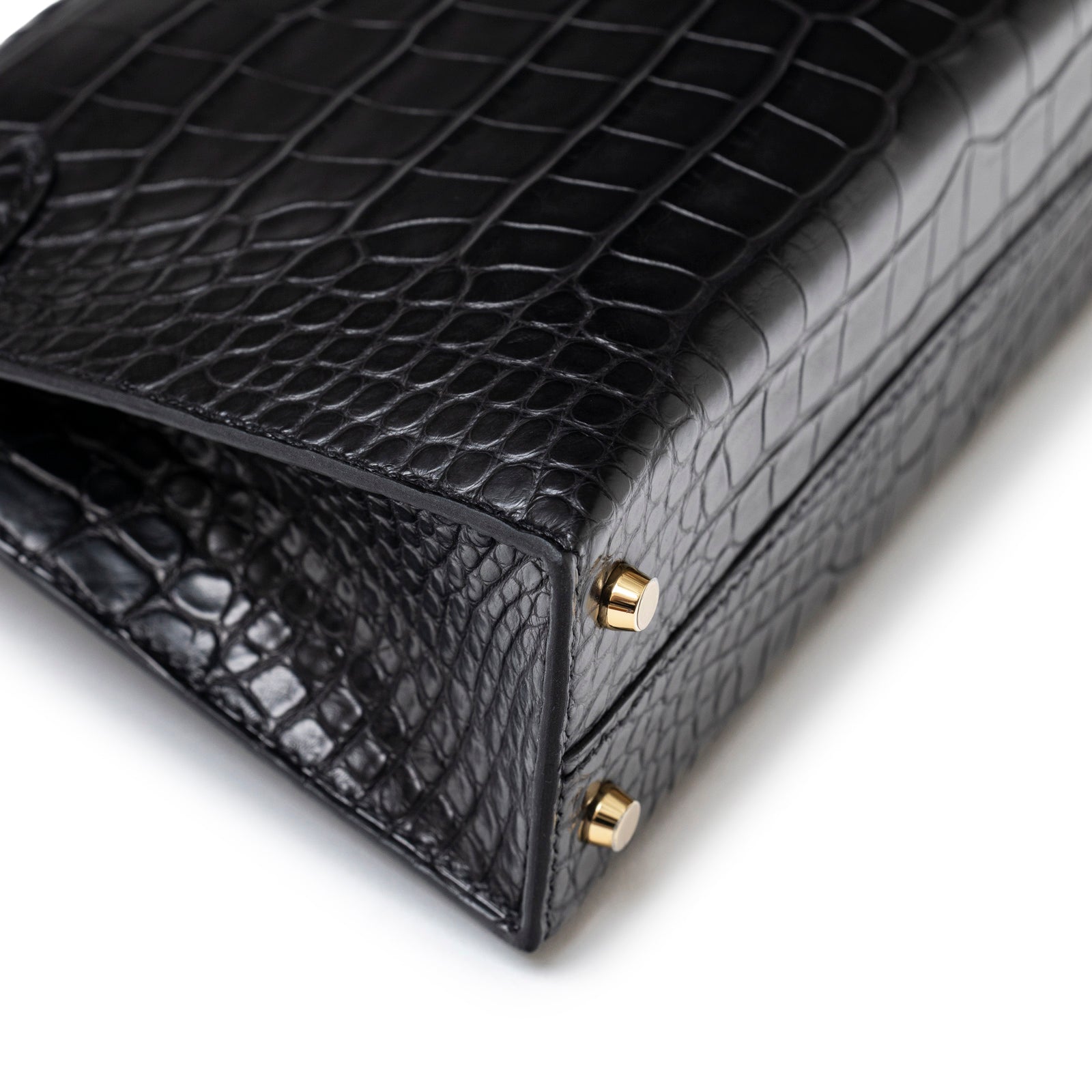 Close-up of bottom corner showcasing black blue matte alligator texture and permabrass hardware feet on Hermès Special Order HSS Horseshoe Mini Kelly II Black Blue Matte Alligator Permabrass Hardware