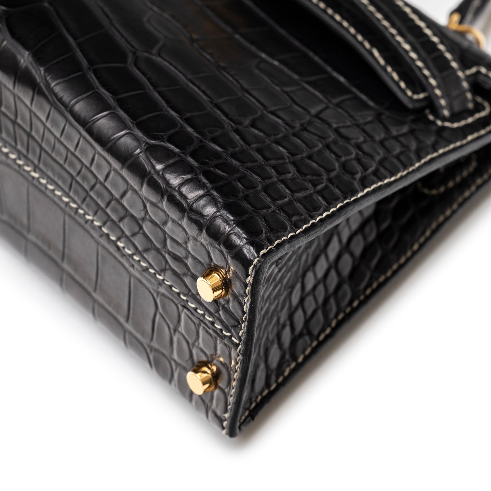 Close-up of bottom corner showing black gris matte alligator leather and gold hardware on Hermès Special Order HSS Horseshoe Mini Kelly II Black Gris Matte Alligator Gold Hardware