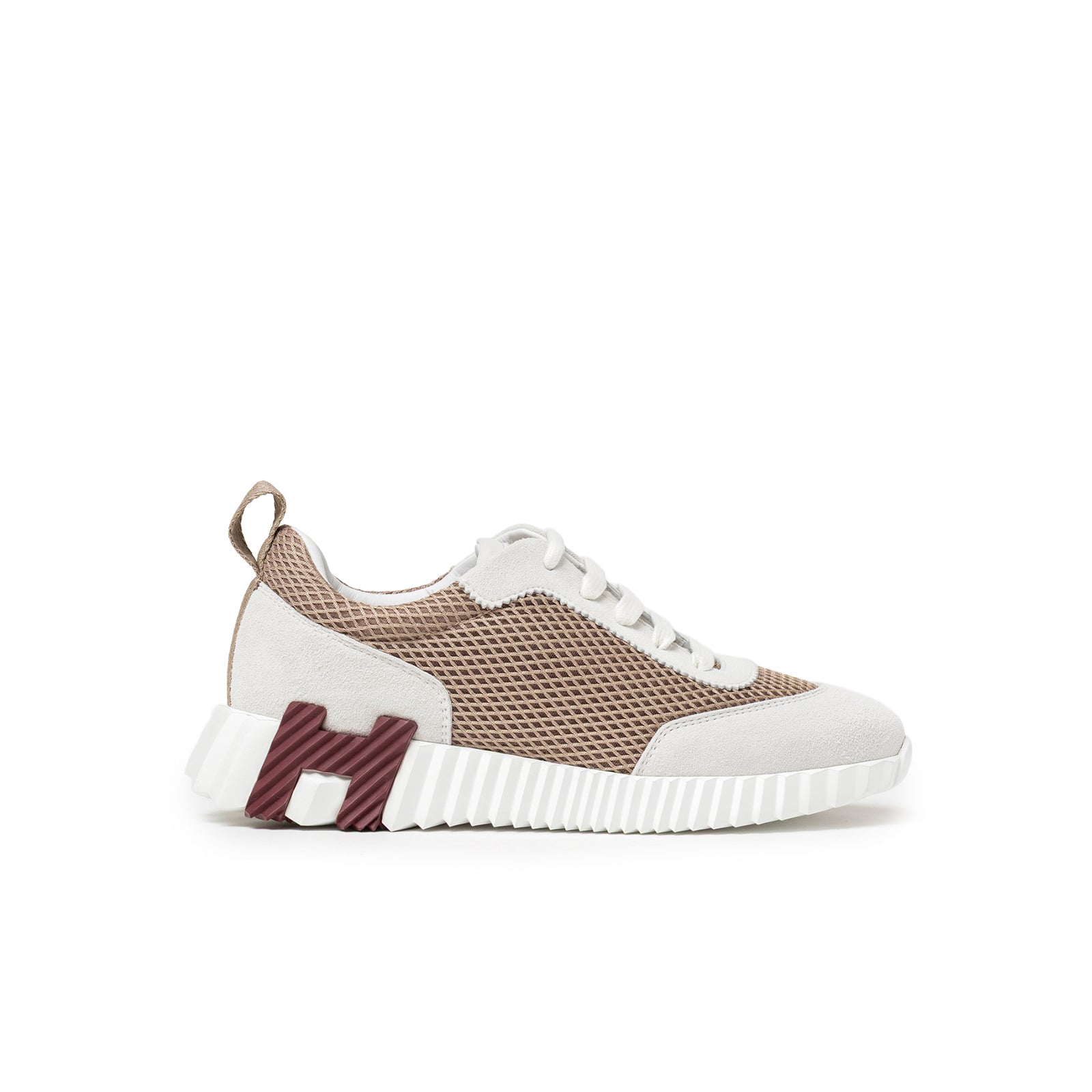 Side profile of Hermès Women's Bouncing Sneaker Beige Argile with mesh upper and rubber sole featuring branded detail