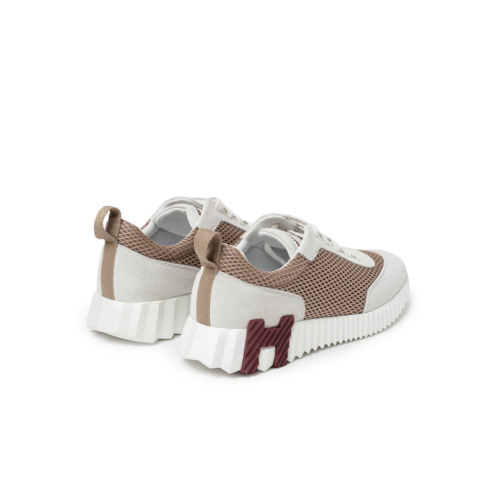 Rear angle of Hermès Women's Bouncing Sneaker Beige Argile with mesh panels and distinctive H heel detail