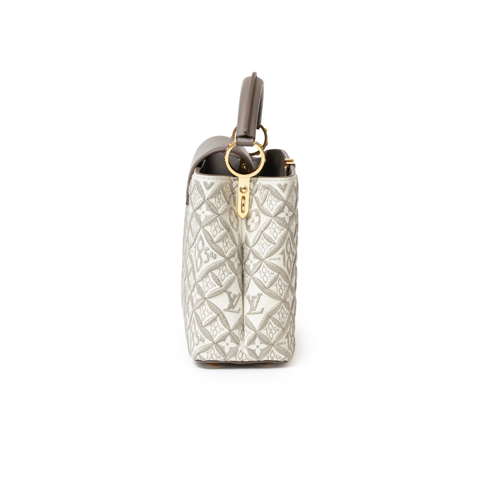 Side view of Louis Vuitton Since 1854 Embroidered Capucines BB Ecru Taupe Calf Gold Hardware handbag showing embroidery and gold clasp details