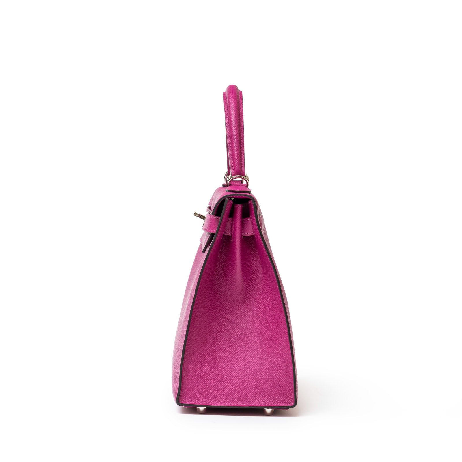 Side view of a Hermès Kelly 28 Sellier Rose Pourpre with top handle, showcasing structured design and minimal hardware.