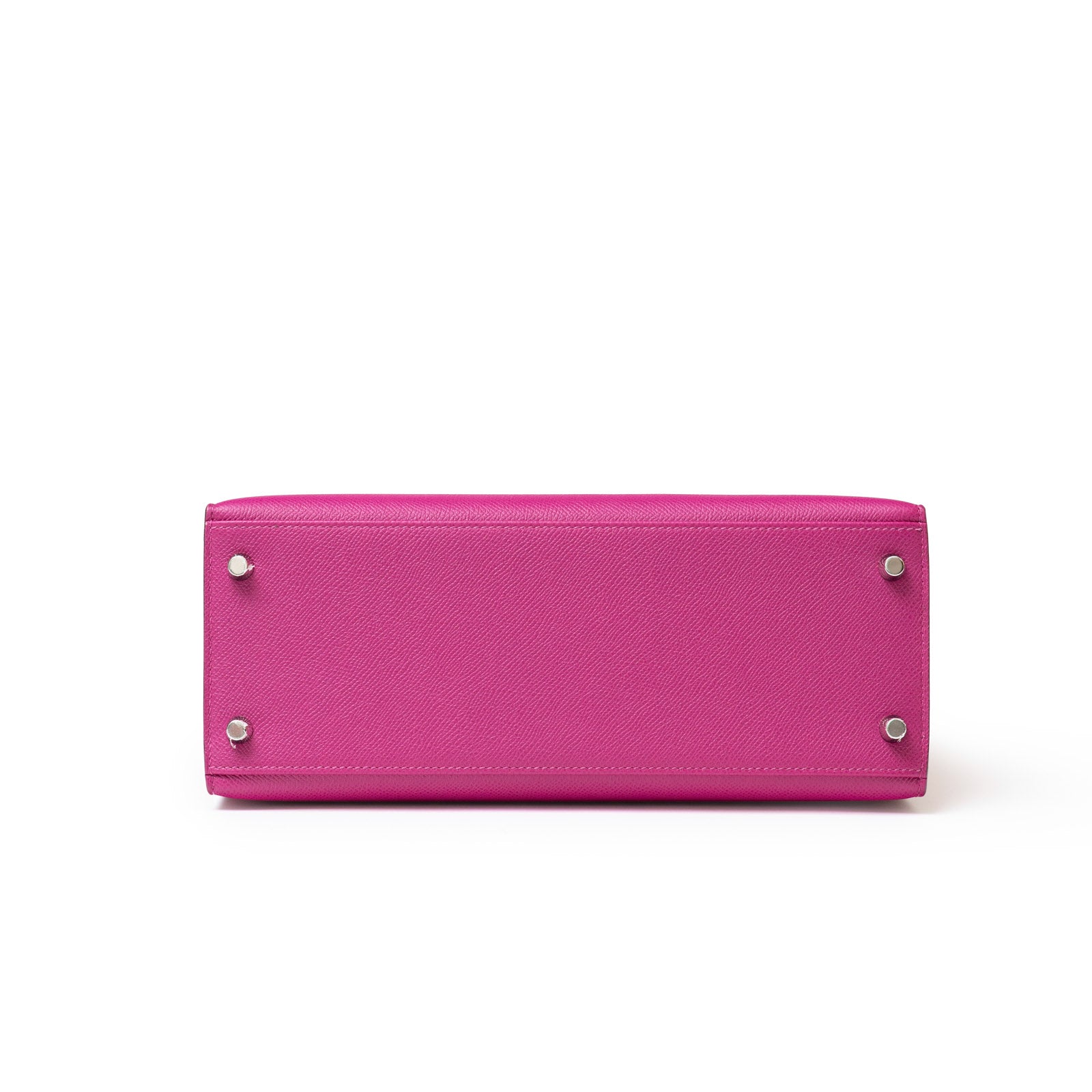 Hermès Kelly 28 Sellier Rose Pourpre bottom view with silver studs, textured surface, on white background.