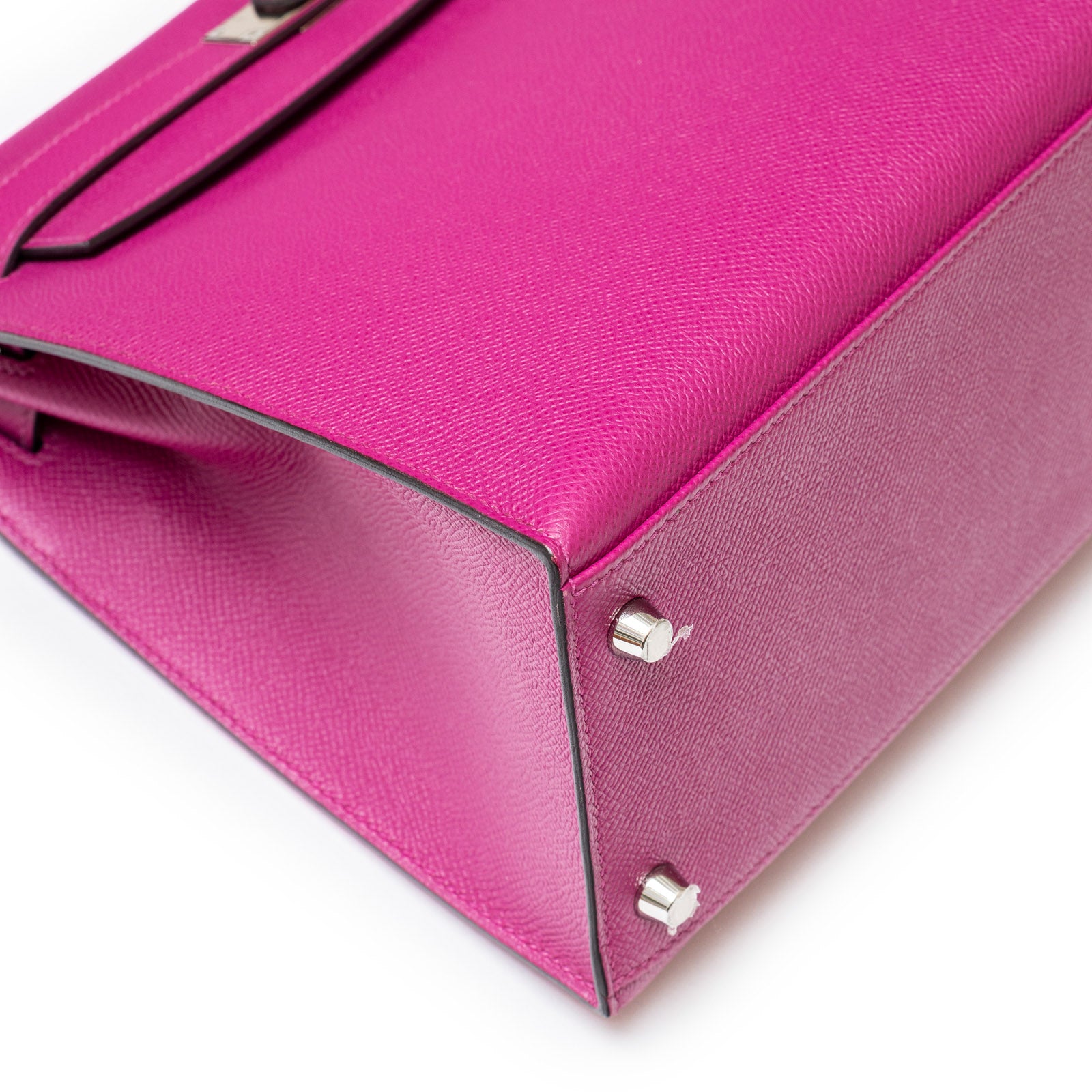 Angled shot of Hermès Kelly 28 Sellier Rose Pourpre base with silver hardware details.