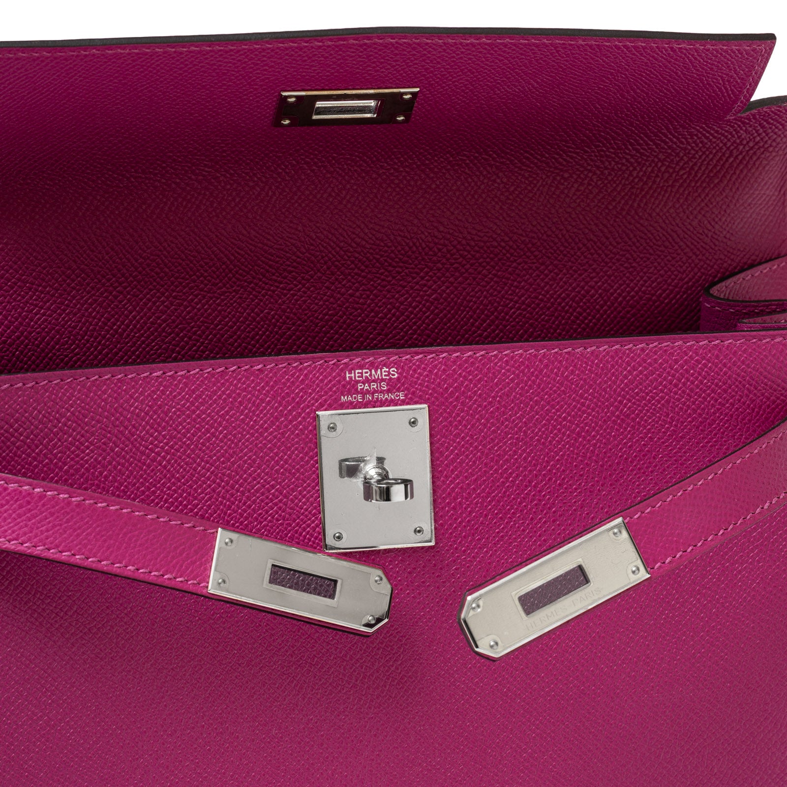 Interior view of Hermès Kelly 28 Sellier Rose Pourpre bag with silver hardware, showing clasp detail.