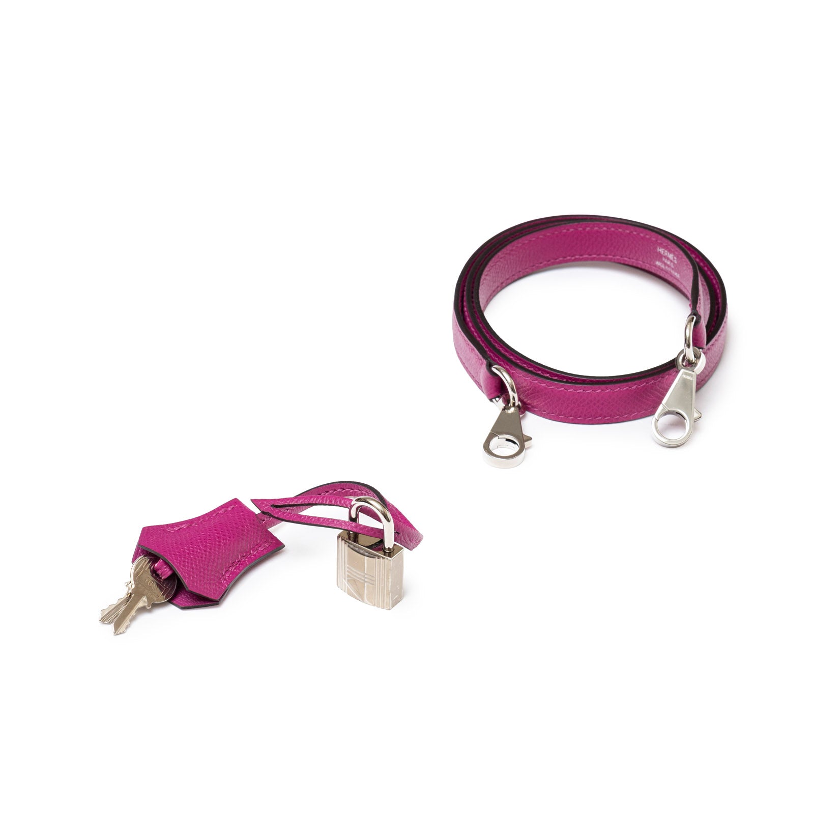 Bracelet with silver hardware and small padlock, keys attached to fob on white background.