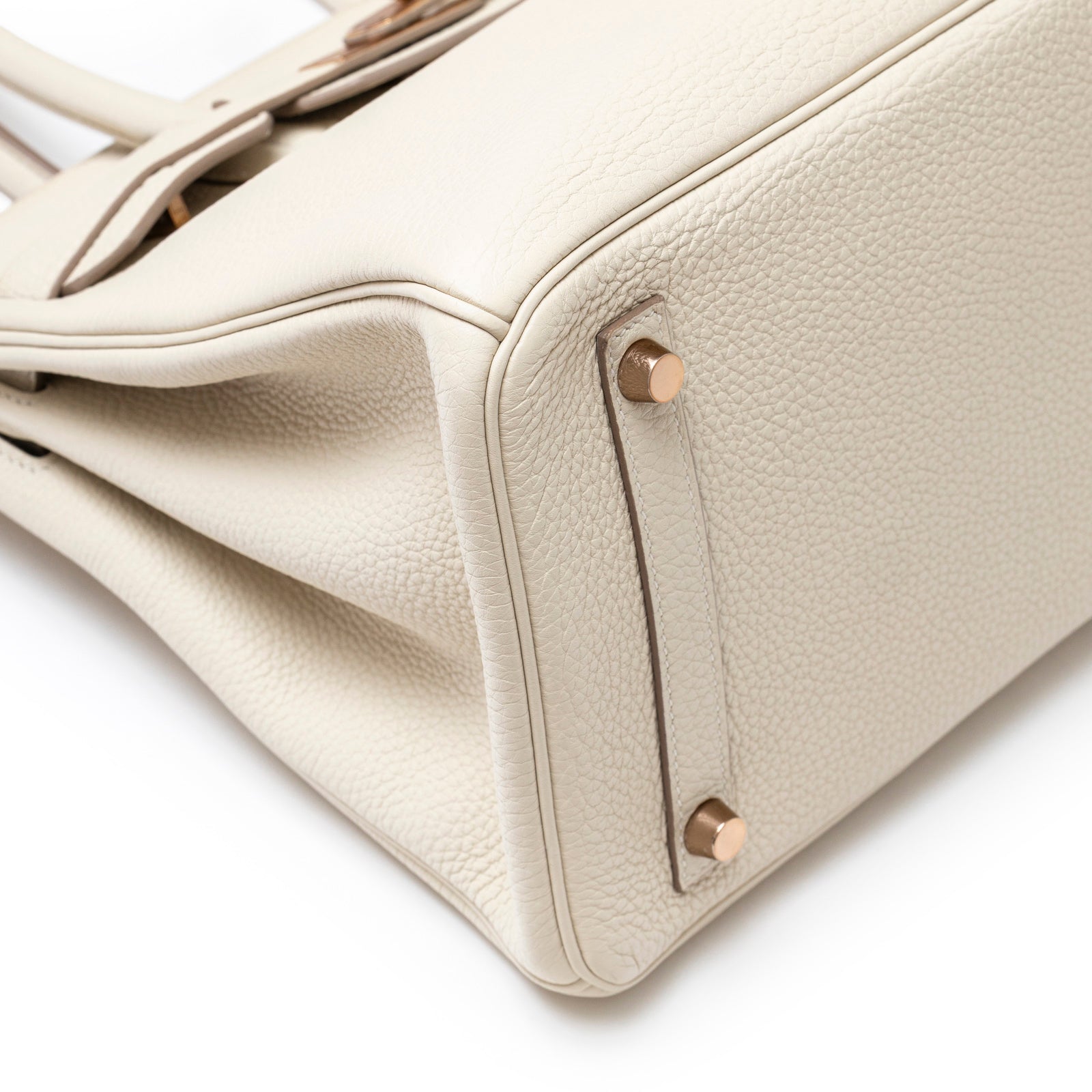 Close-up bottom view of Hermès Birkin 30 Craie Togo Rose Gold Hardware showing textured leather and studs