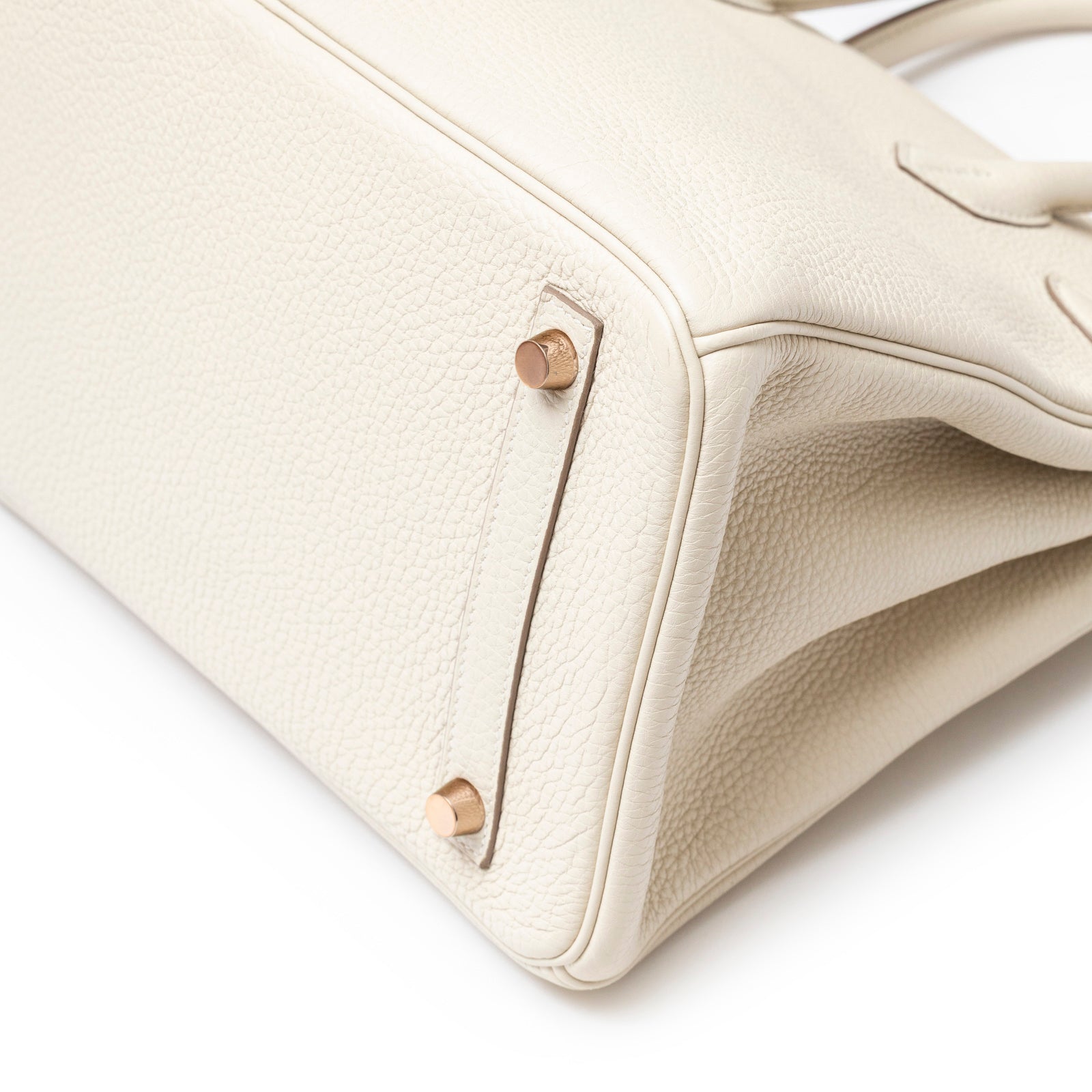 Close-up of the bottom corner showing rose gold hardware on Hermès Birkin 30 Craie Togo Rose Gold Hardware bag