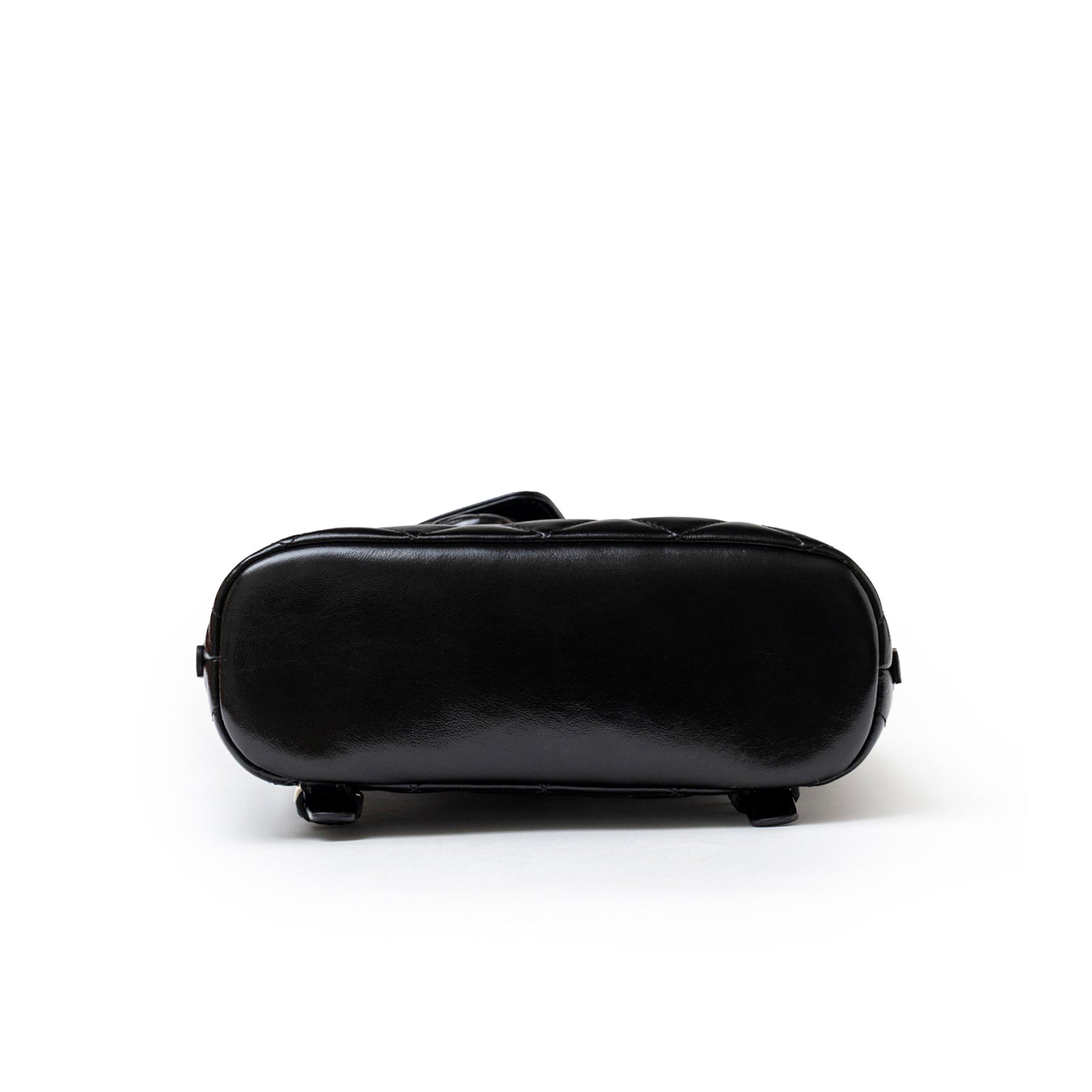 Bottom view of Chanel My Pocket Backpack Black Shiny Calfskin Gold Hardware showing smooth base and feet details