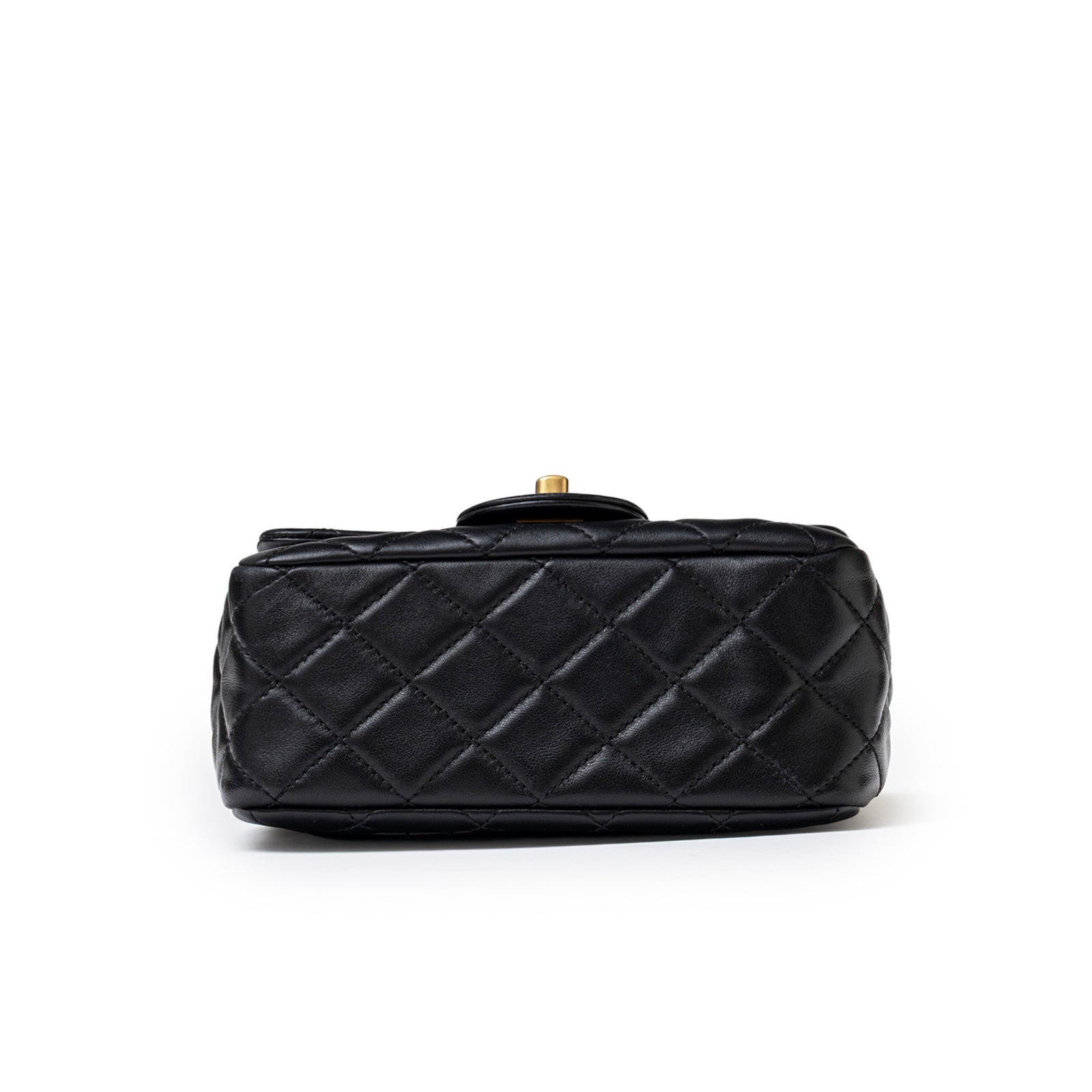 Bottom view of Chanel Mini Square Pearl Crush Flap Bag Black Lambskin Aged Brushed Gold Hardware showing quilted texture
