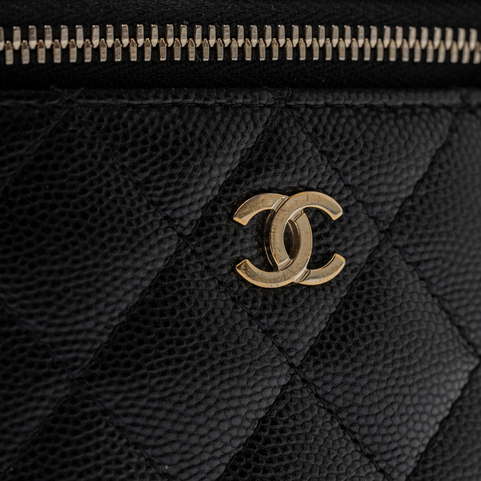 Close-up of gold hardware and textured black caviar leather on Chanel Mini Coco Beauty Vanity Case on Chain Black Caviar Gold Hardware