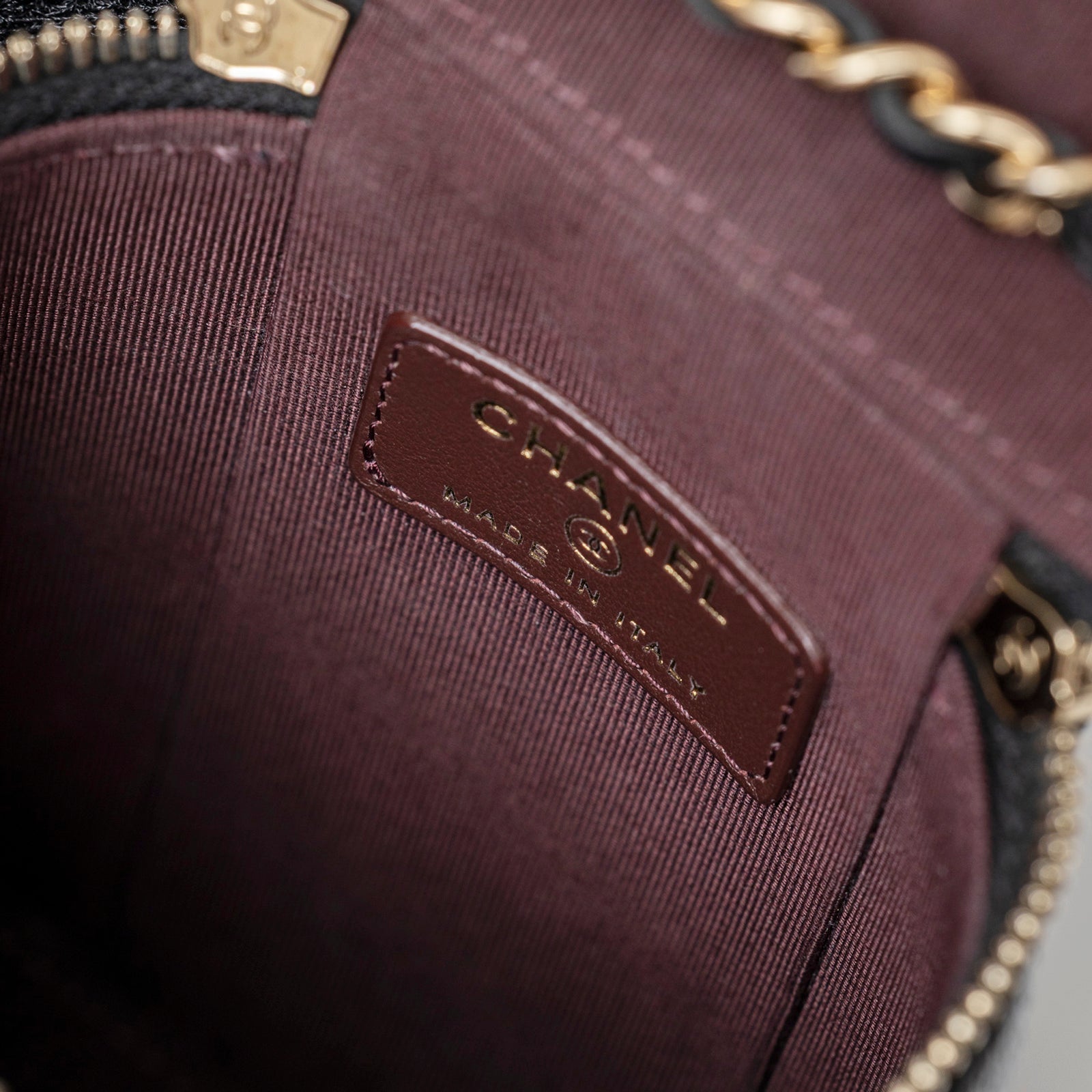 Close-up interior view of Chanel Mini Coco Beauty Vanity Case on Chain Black Caviar Gold Hardware showing logo patch and lining details