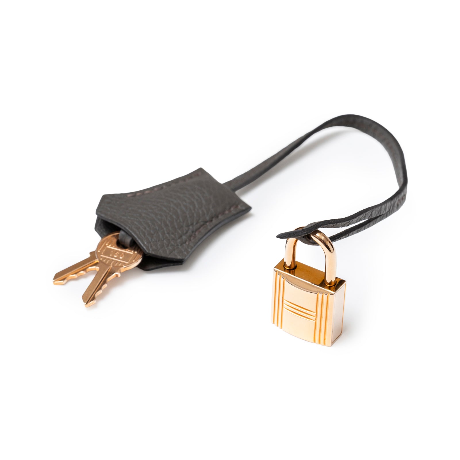 Close-up of the Hermès Birkin 30 Etain Togo Rose Gold Hardware padlock and key holder with two keys attached