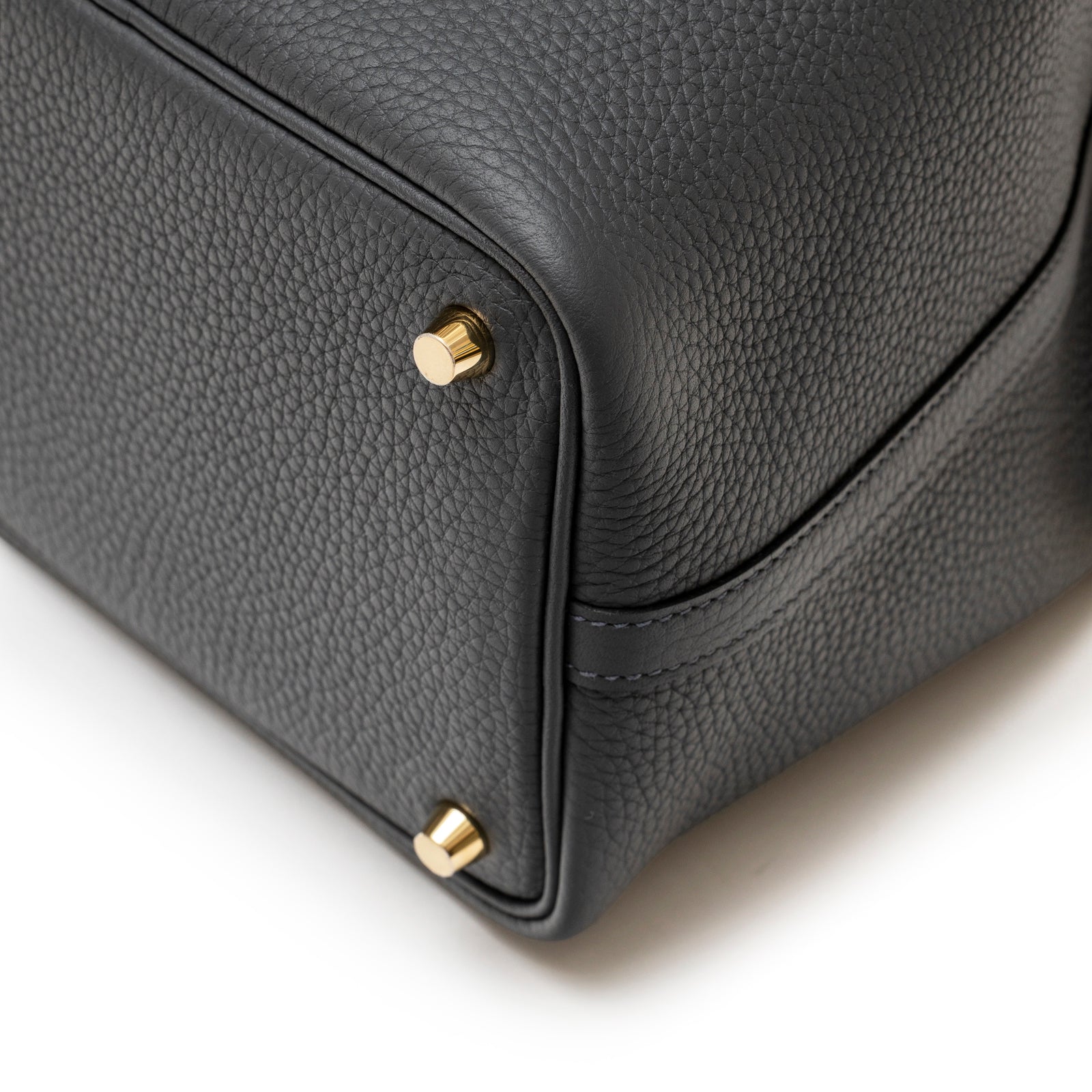 Close-up of bottom corner showing Permabrass hardware on Hermès Picotin 18 Gris Misty Clemence leather bag