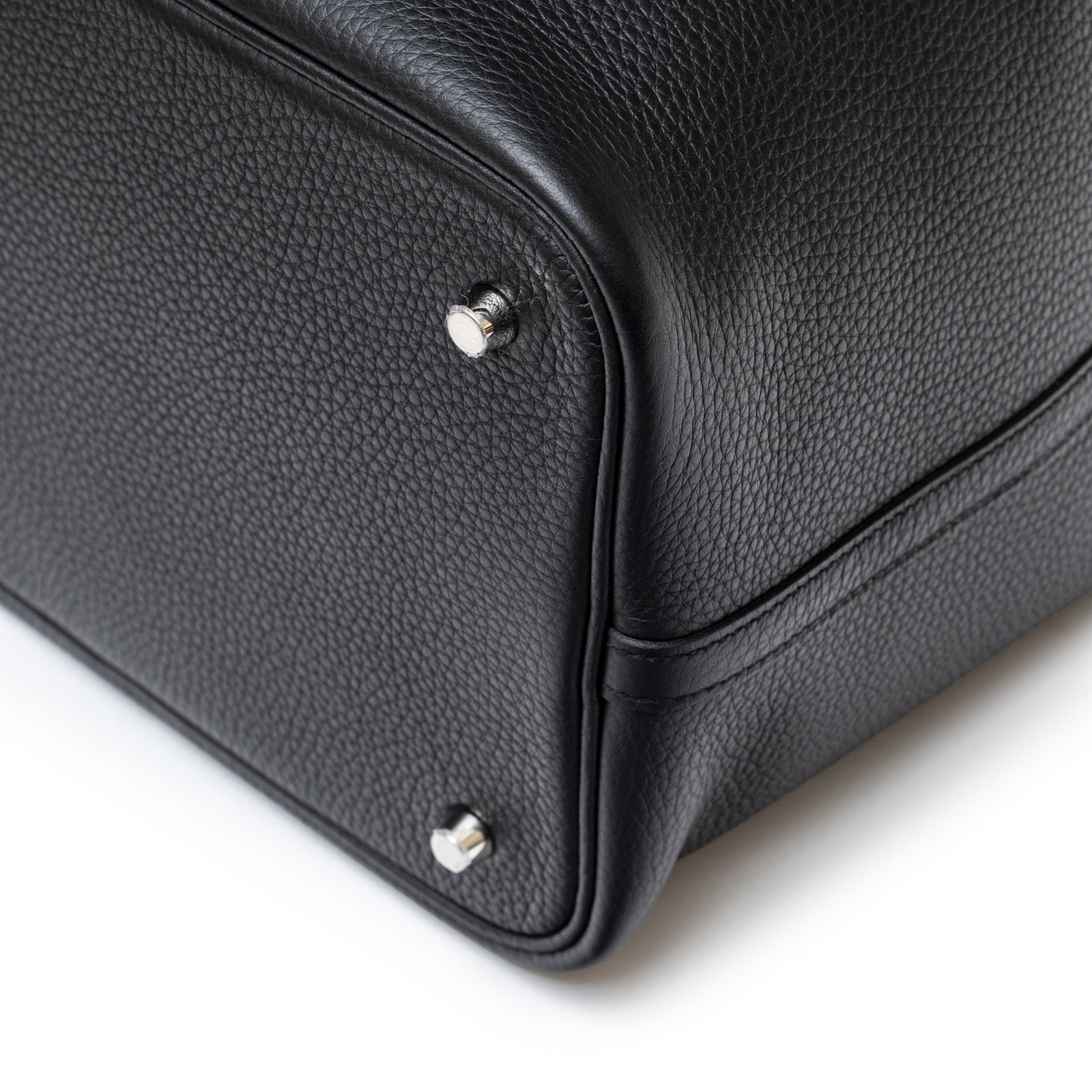 Close-up of bottom corner showing textured black Clemence leather and palladium hardware on Hermès Picotin 22 Black Clemence Palladium Hardware