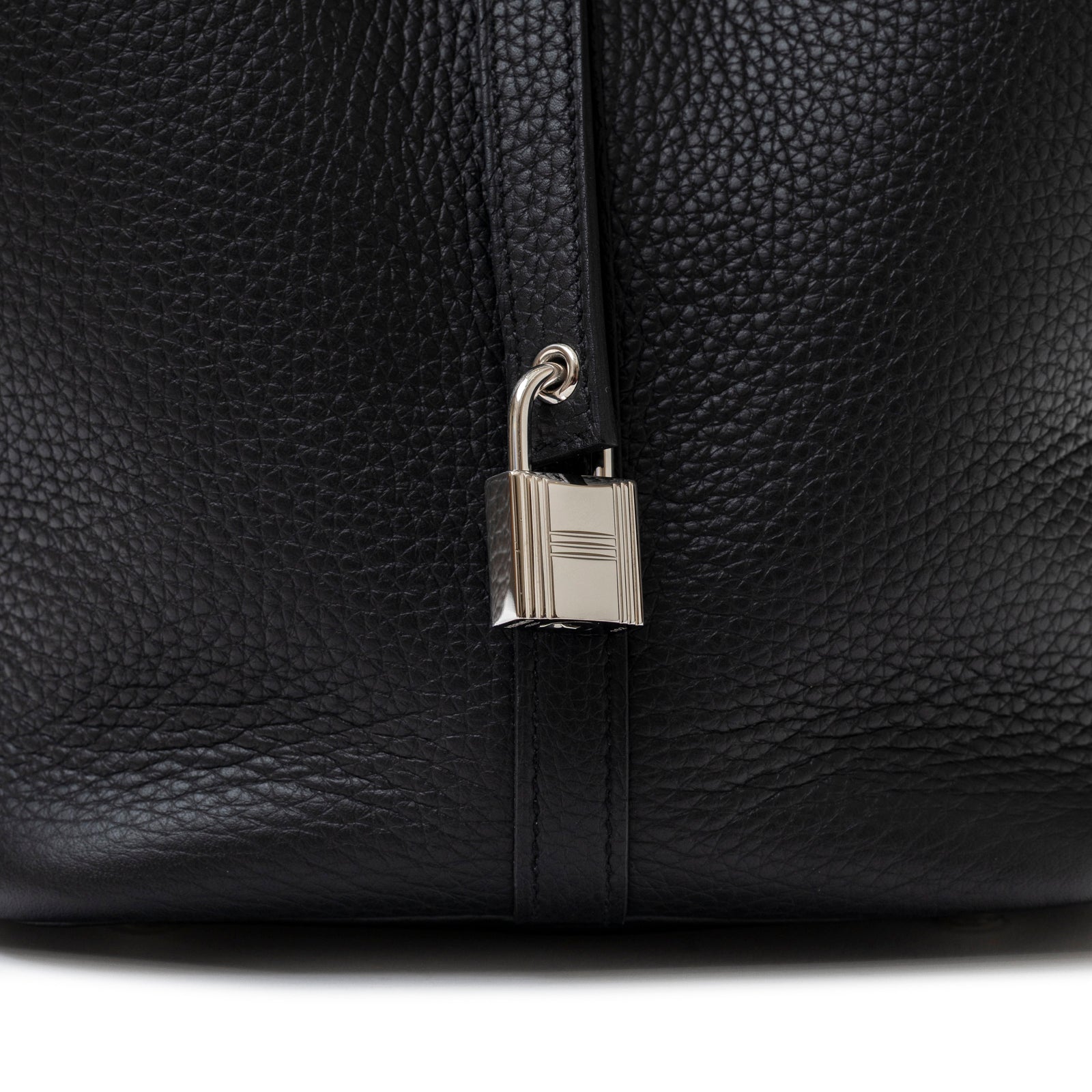 Close-up view of the Hermès Picotin 22 Black Clemence Palladium Hardware lock and textured leather detail