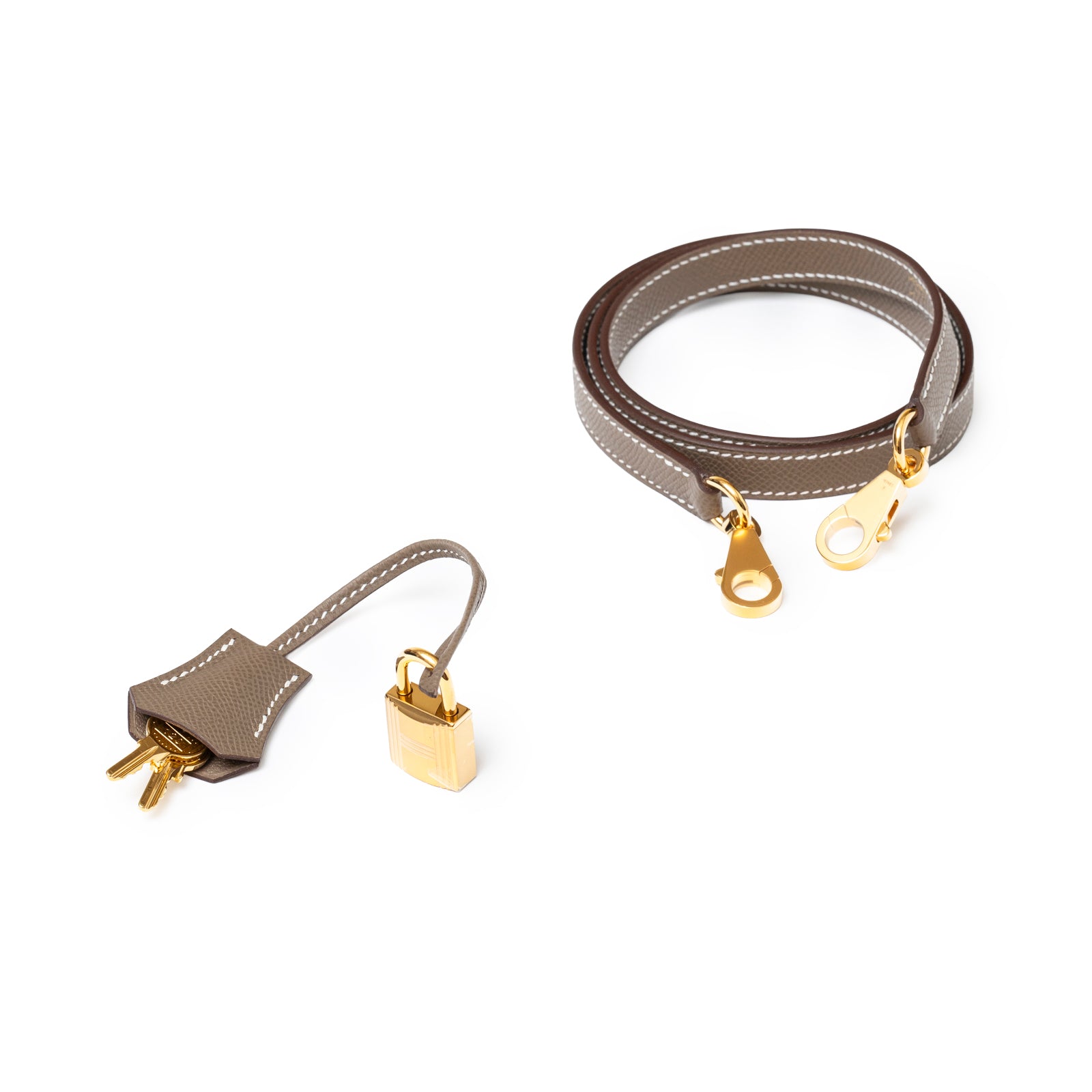 Gold hardware lock and keys with tan leather clochette and matching Hermès Kelly 25 Sellier Etoupe Epsom shoulder strap