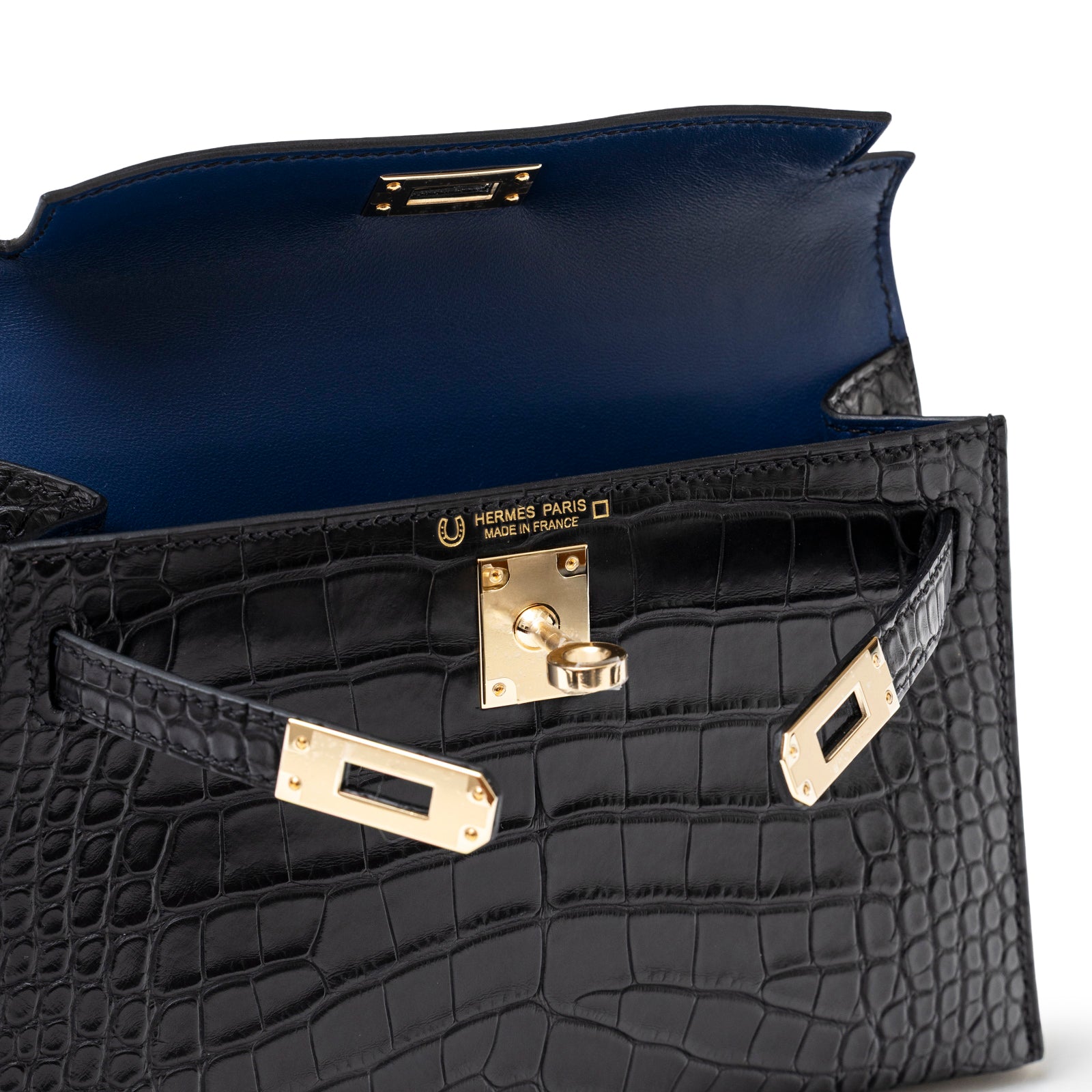 Close-up interior view of Hermès Horseshoe Mini Kelly II Black/Blue Matte Alligator Permabrass Hardware showing clasp and stitching details