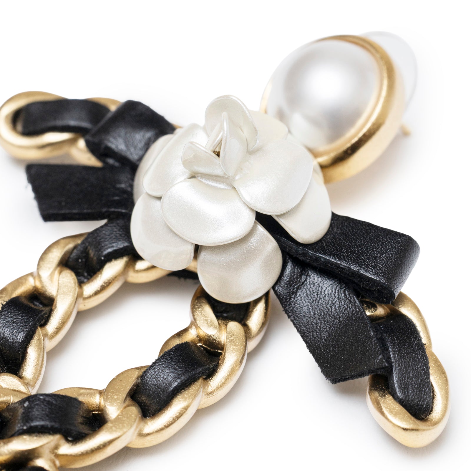Close-up of Chanel Black Bow With Camellia CC Earrings Gold Hardware showing pearl, camellia, and chain details.