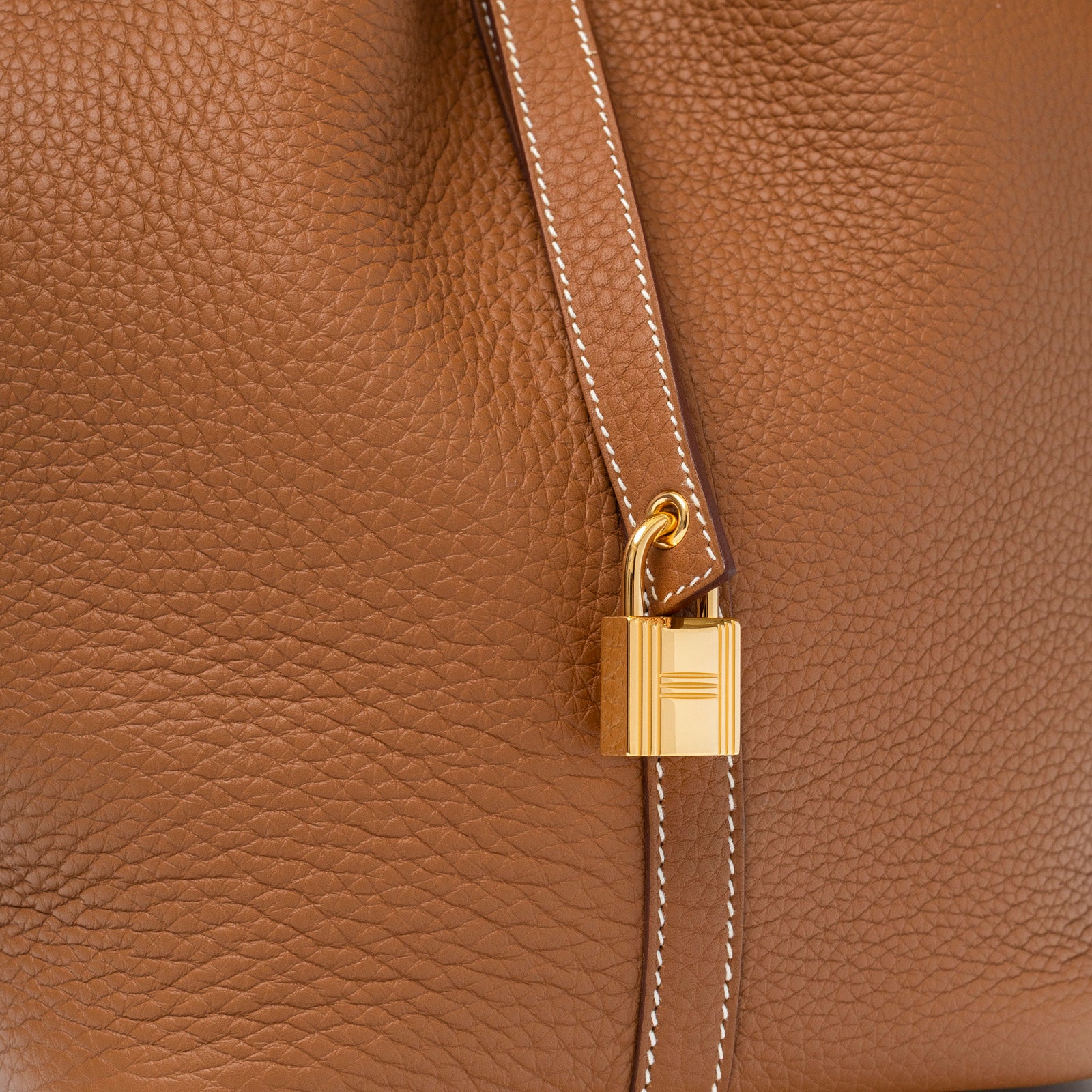 Close-up of gold hardware lock and textured leather on Hermès Picotin 22 Gold Clemence Gold Hardware handbag