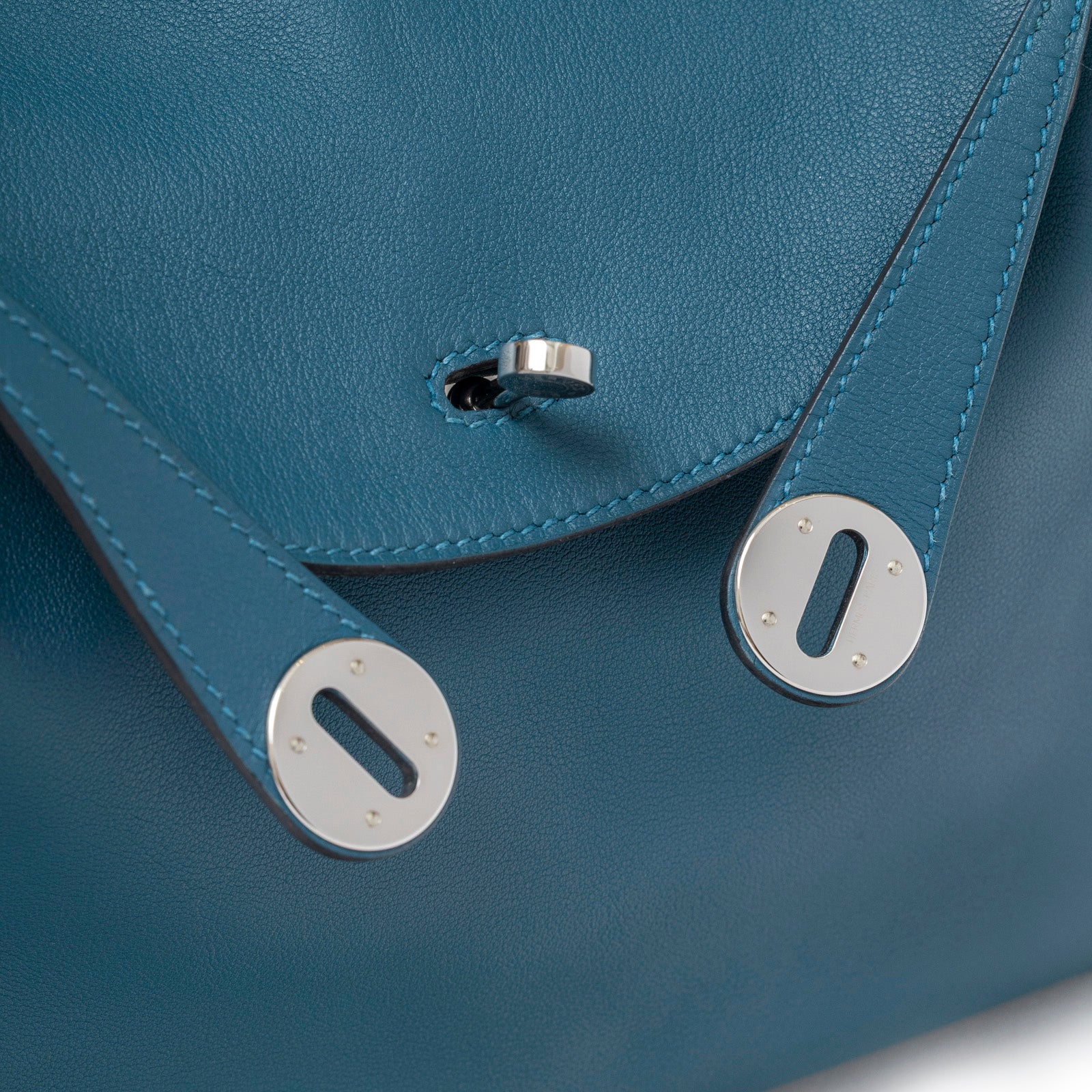 Close-up of Hermès Lindy 26 Colvert Swift Palladium Hardware showing clasp and leather strap stitching details