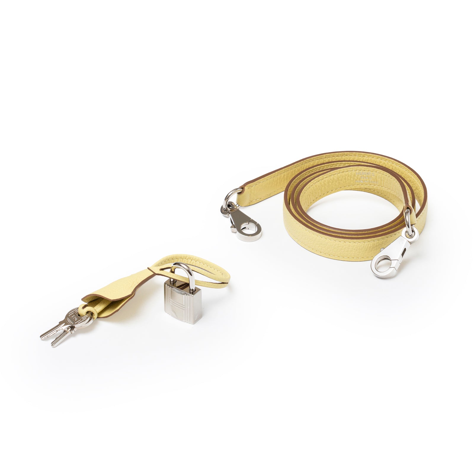 Close-up of Hermès Kelly 25 Retourne Togo Jaune Poussin Palladium Hardware lock, keys, clochette, and shoulder strap detail