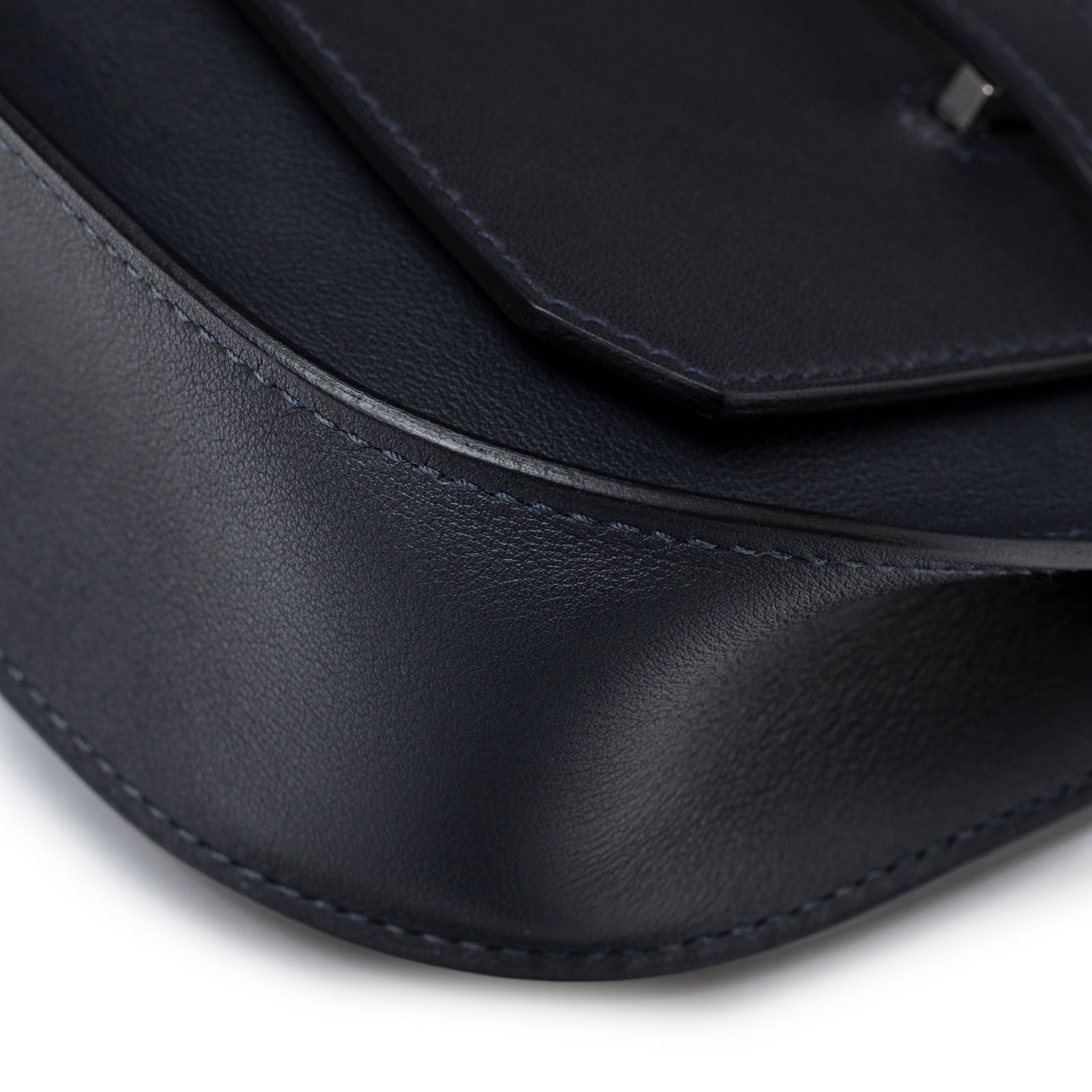 Close-up of smooth leather corner stitching on Hermès Mini Jypsiere Caban Swift Palladium Hardware bag