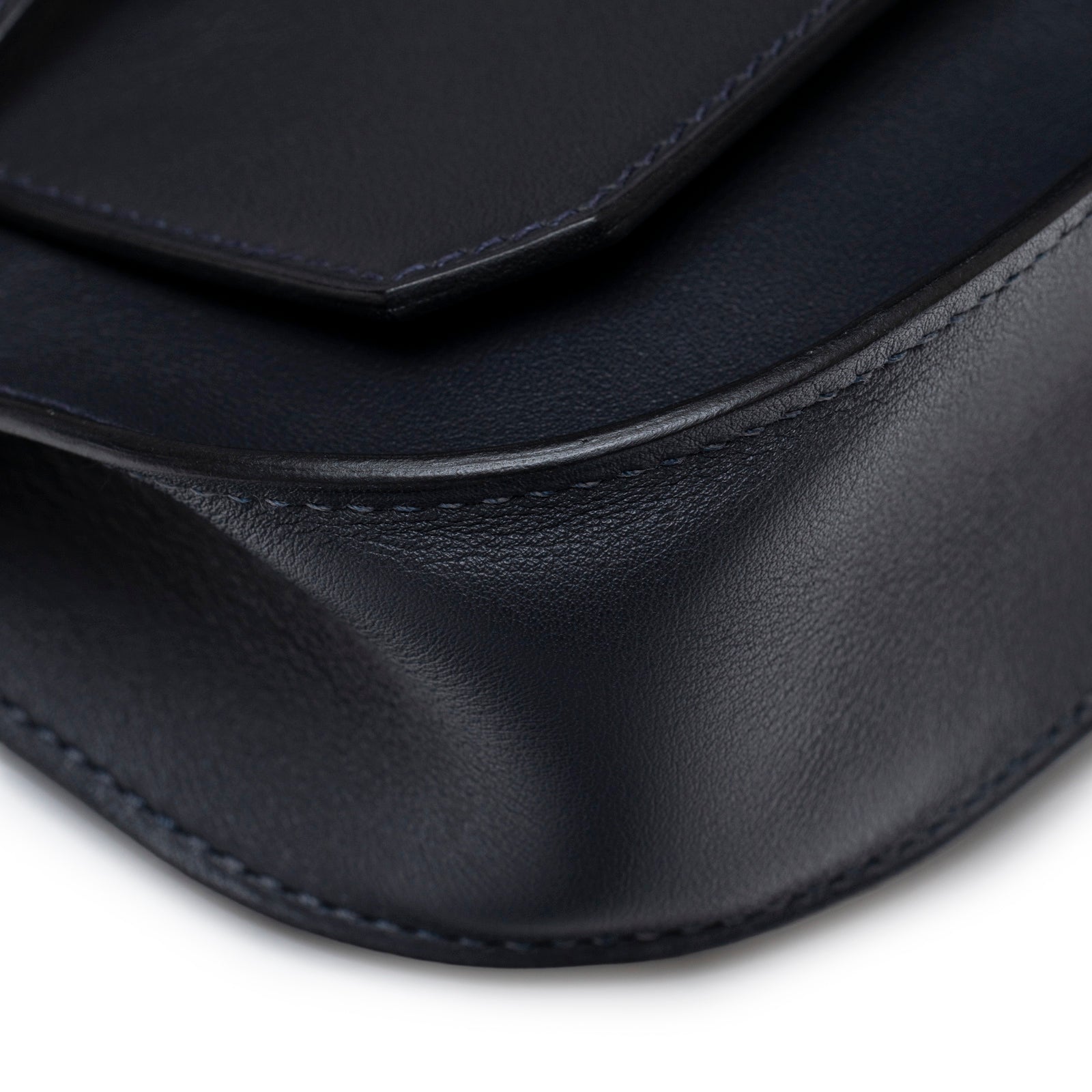 Close-up of smooth leather corner on Hermès Mini Jypsiere Caban Swift Palladium Hardware bag showing fine stitching detail