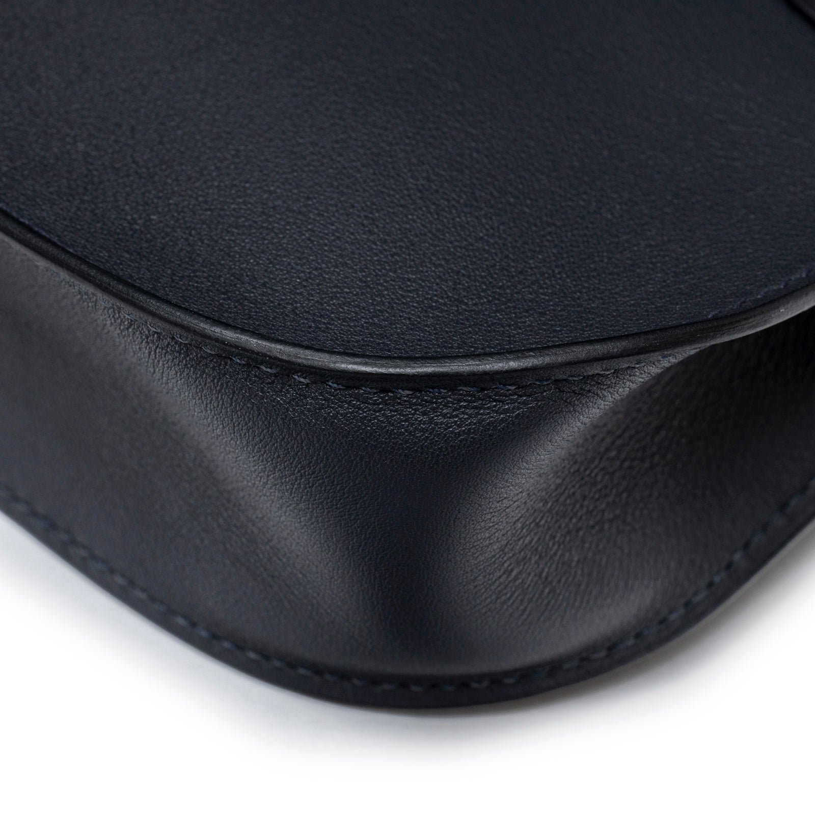 Close-up of curved leather corner and fine stitching on Hermès Mini Jypsiere Caban Swift Palladium Hardware bag