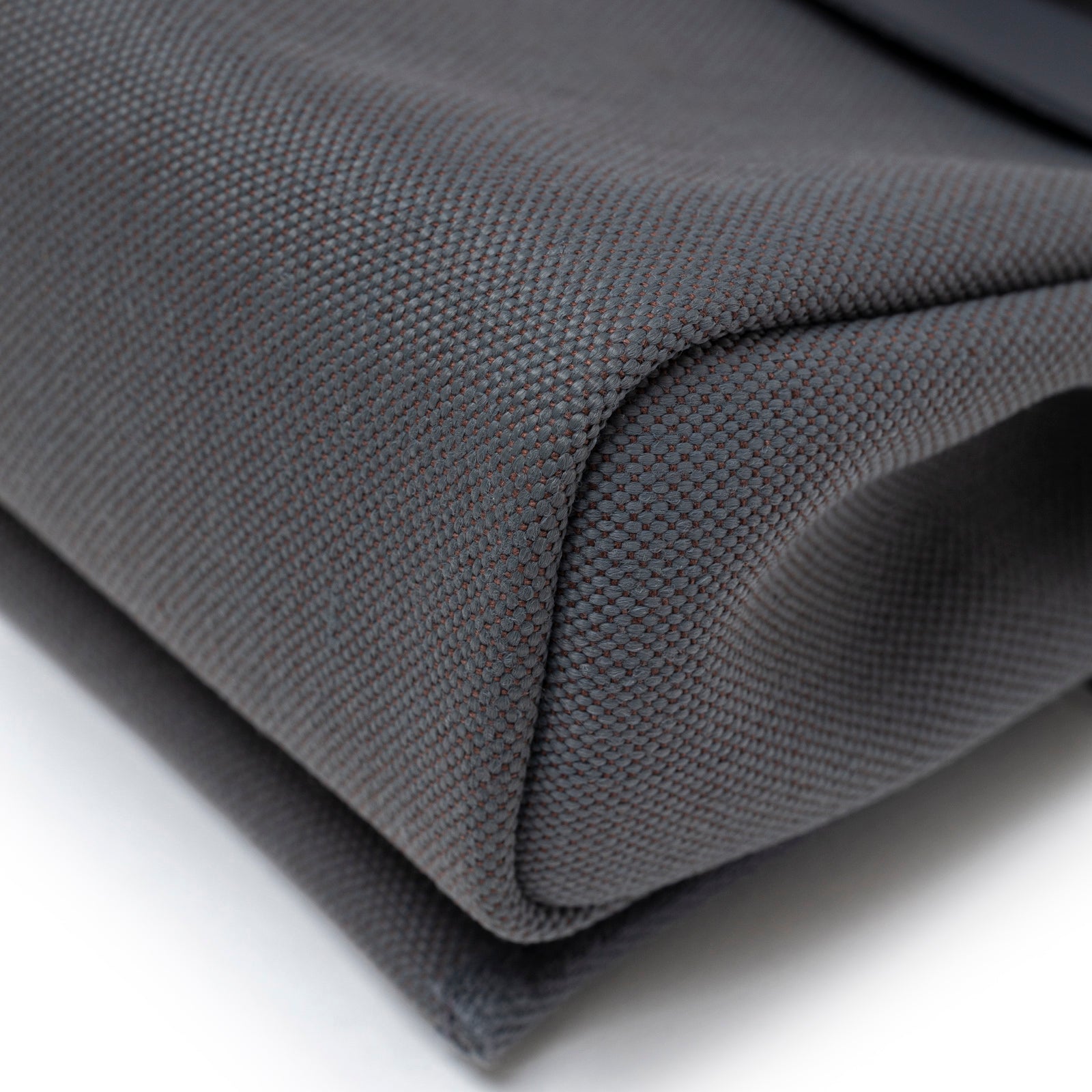 Close-up angled view of Hermès Mini Herbag Zip 20 Ardoise Toile and Vache Hunter Palladium Hardware fabric texture corner detail