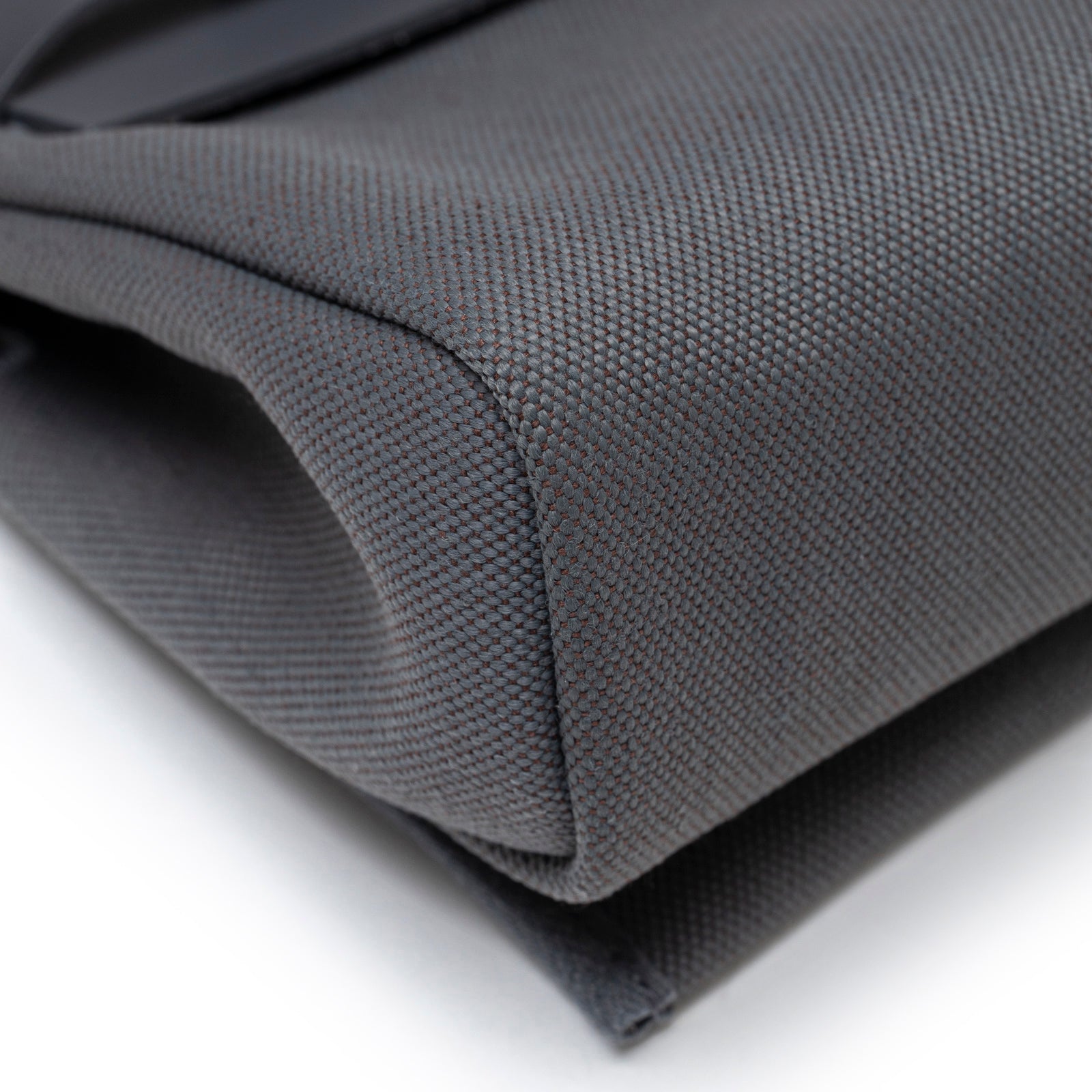 Close-up angled view of Hermès Mini Herbag Zip 20 Ardoise Toile and Vache Hunter Palladium Hardware showing textured fabric corner detail