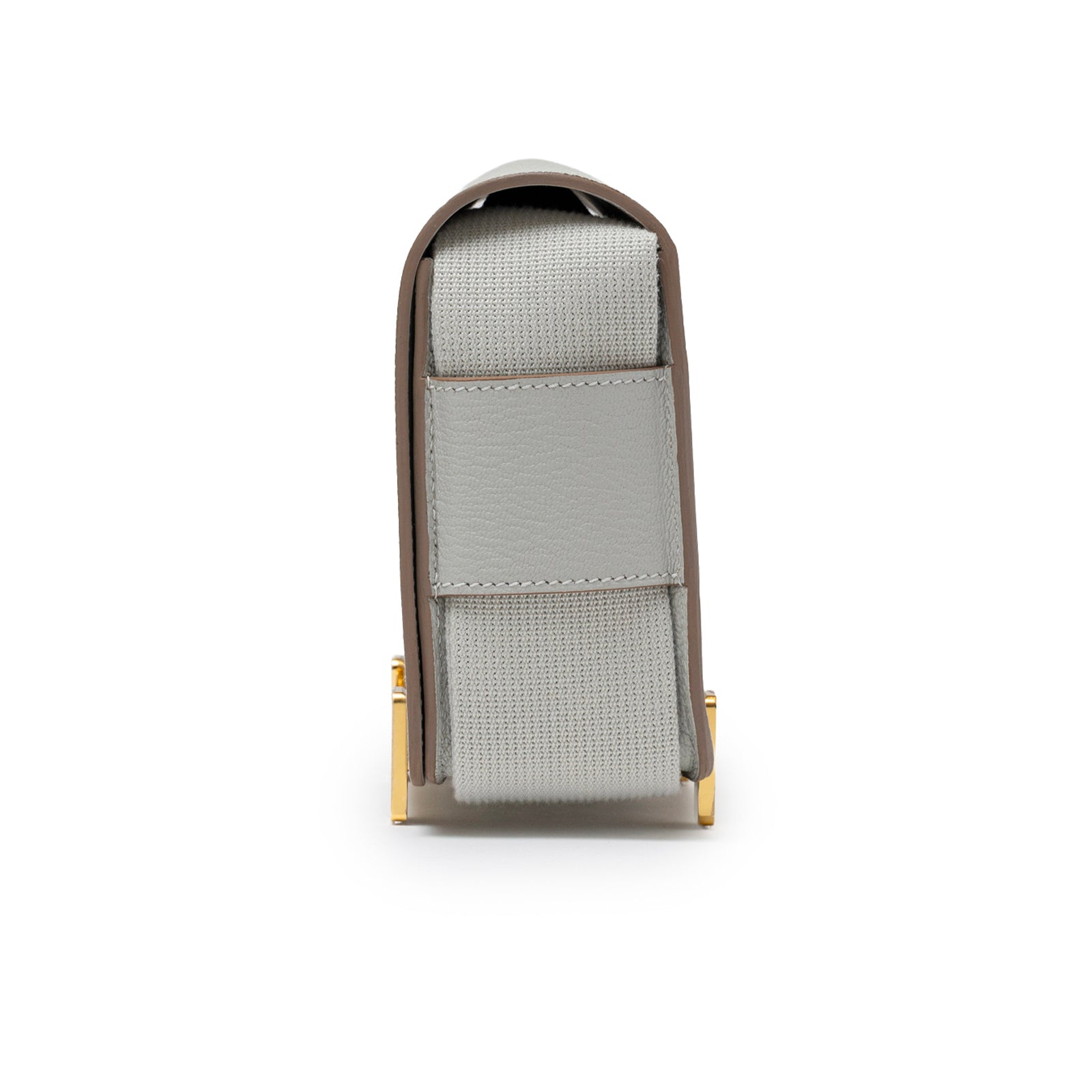 Side view of Hermès Geta Gris Perle Chevre Mysore Gold Hardware showing gray strap and gold hardware details