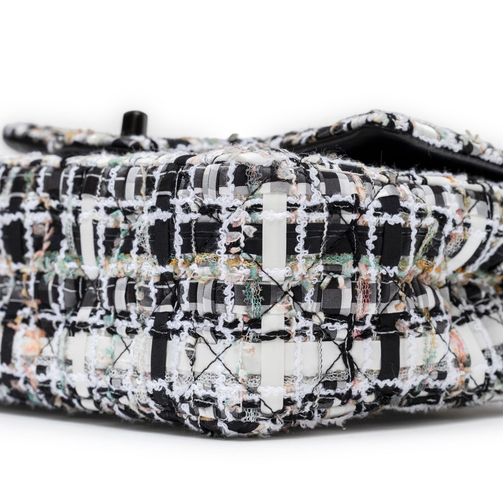 Close-up side view of Chanel Mini Classic Flap Black and White Tweed Black Hardware showing detailed stitching and fabric texture