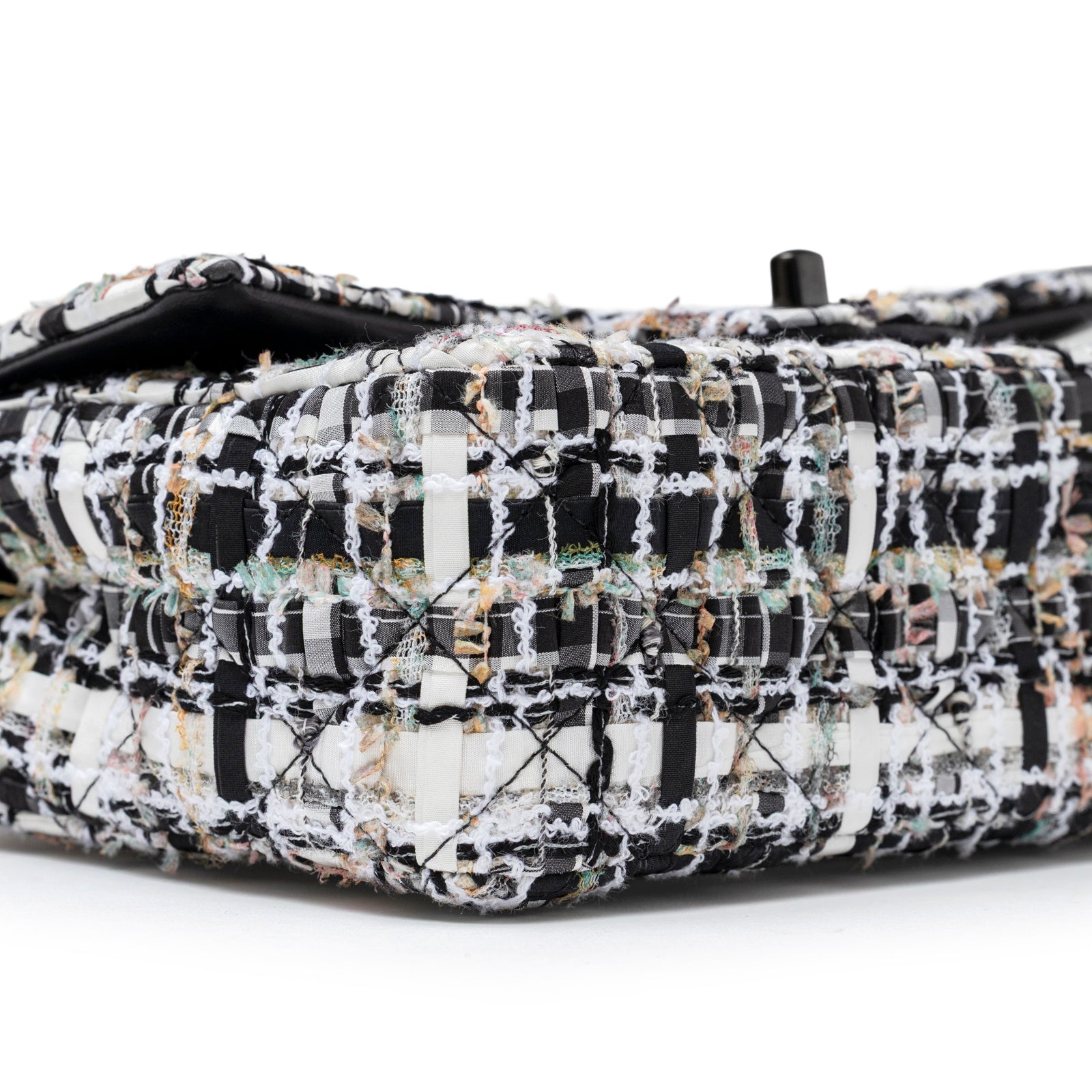 Close-up angled shot of Chanel Mini Classic Flap Black and White Tweed Black Hardware corner detailing