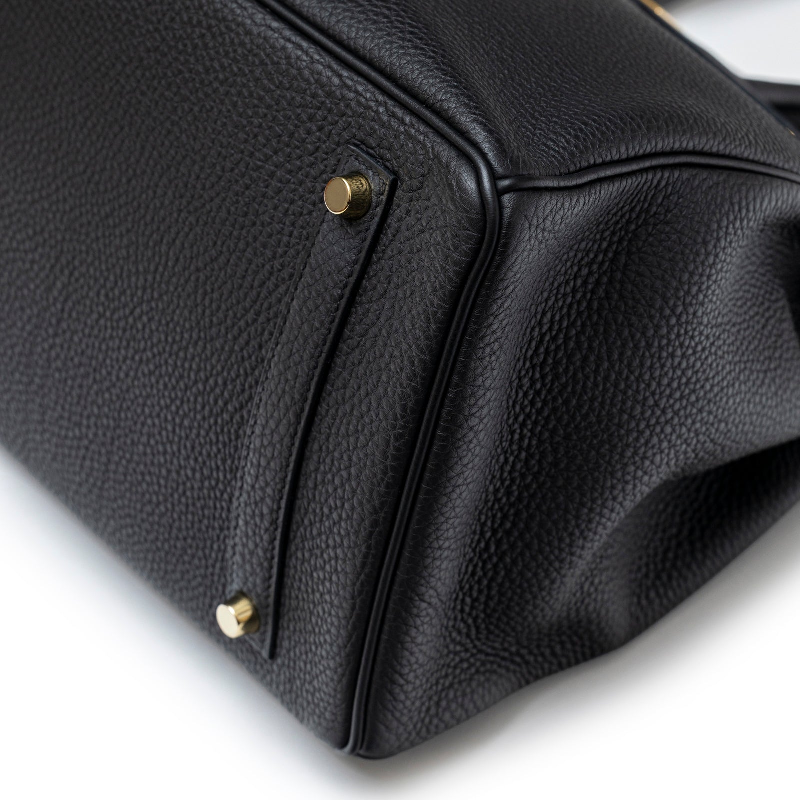 Close-up of bottom corner on Hermès Birkin 35 Black Togo Gold Hardware showing pebbled texture and protective feet