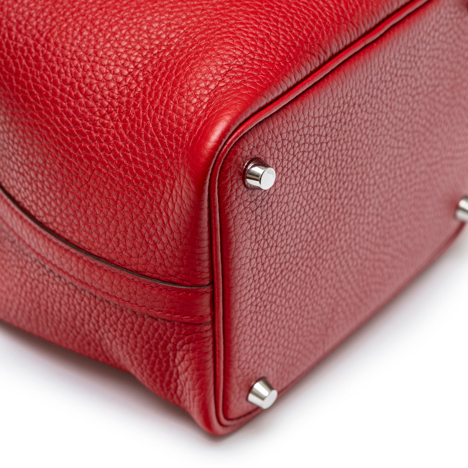 Close-up of bottom corner and palladium feet on Hermès Picotin 18 Rouge Casaque Clemence Palladium Hardware bag