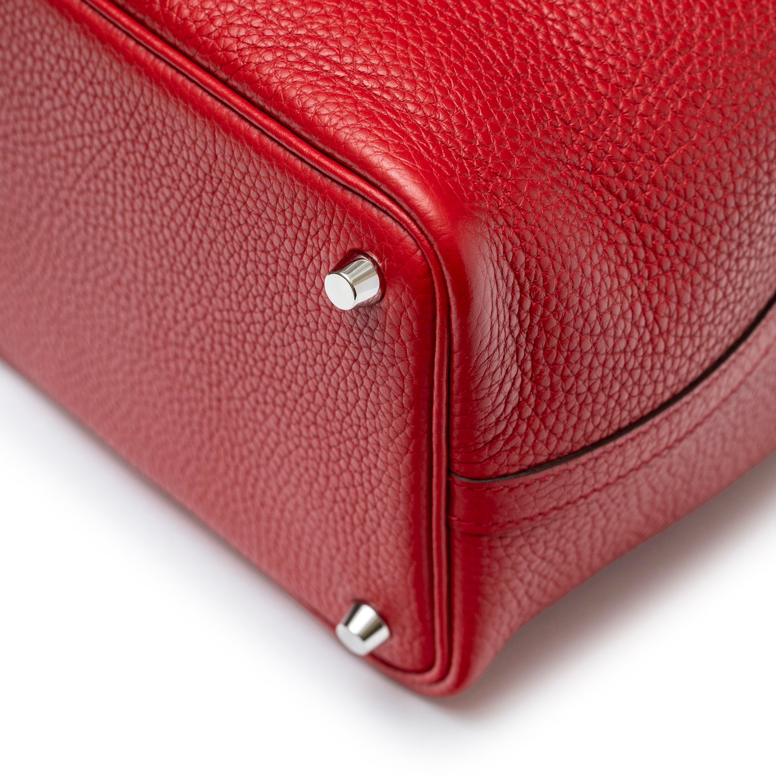 Close-up of bottom corner and palladium feet on Hermès Picotin 18 Rouge Casaque Clemence Palladium Hardware bag