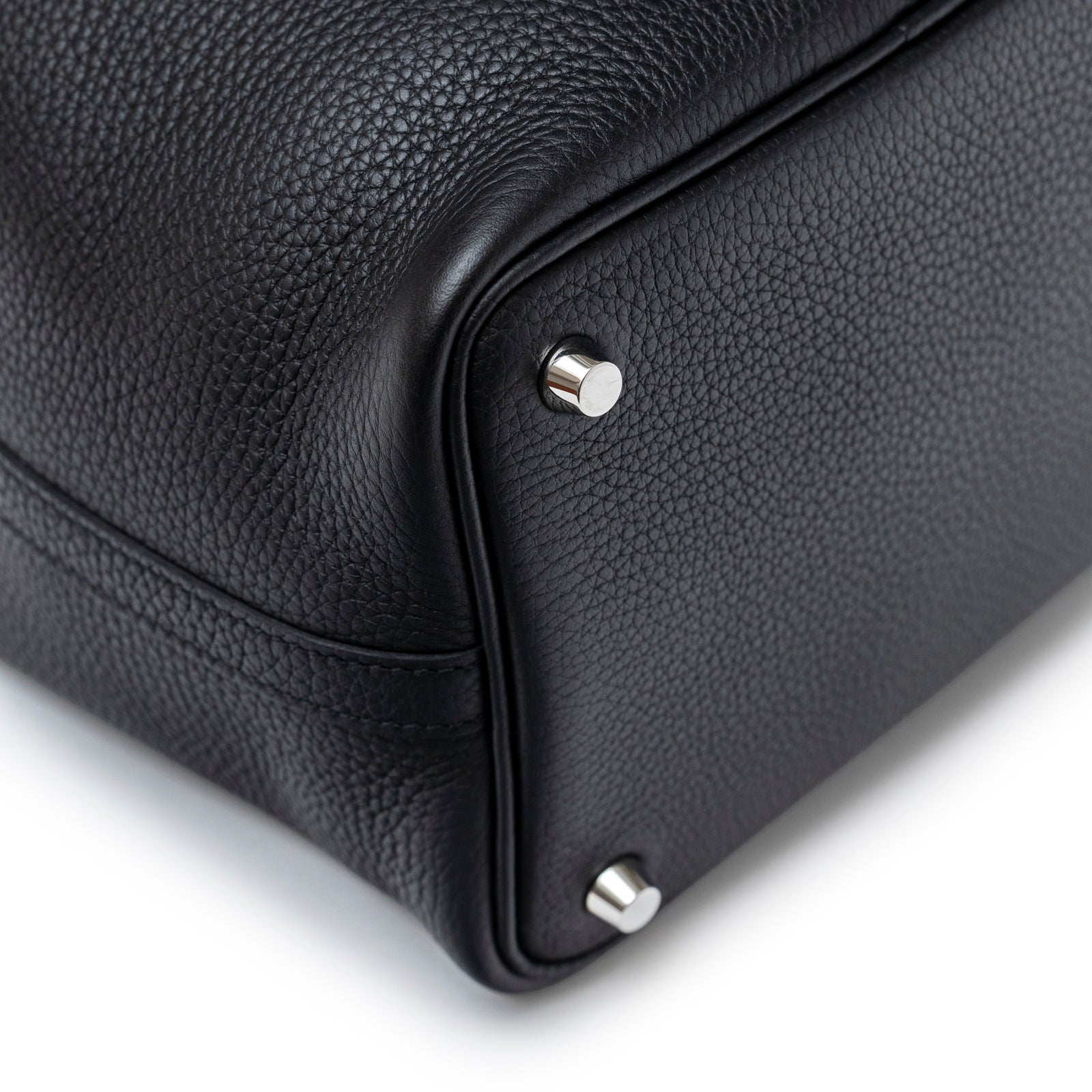 Close-up of bottom corner and palladium hardware feet on Hermès Picotin 18 Black Clemence Palladium Hardware bag