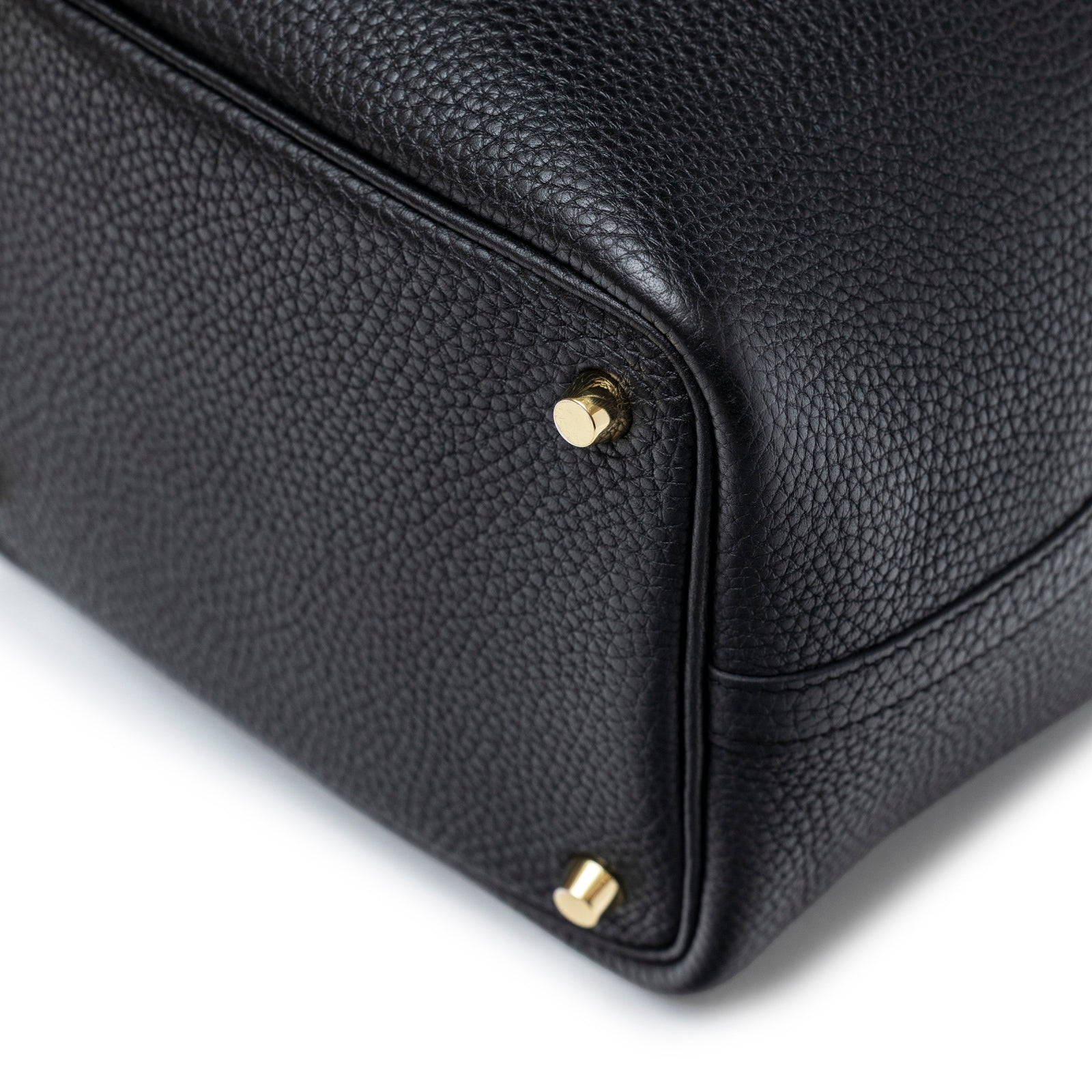 Close-up of bottom corner on Hermès Picotin 18 Black Clemence Gold Hardware showing textured leather and gold feet