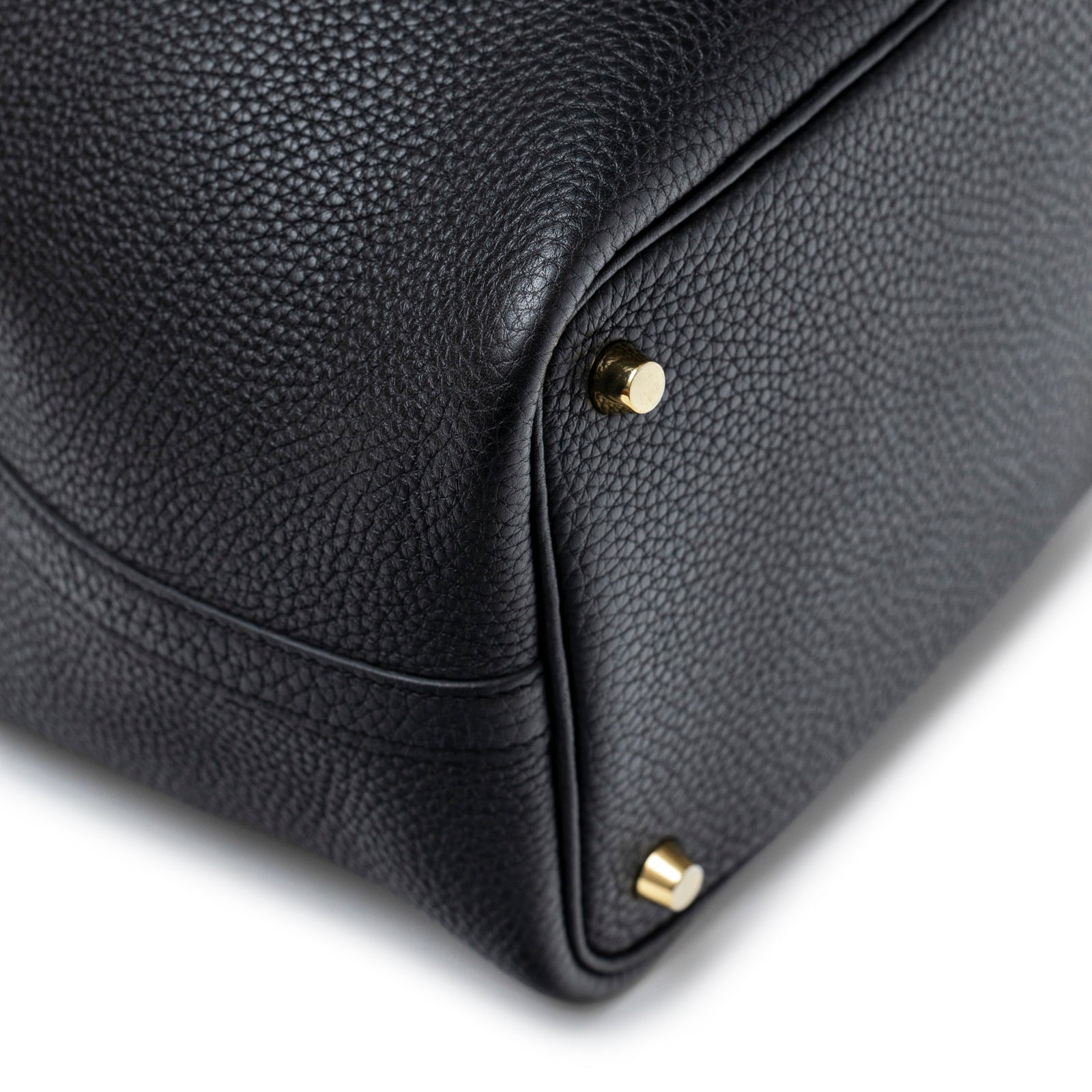 Close-up of bottom corner on Hermès Picotin 18 Black Clemence Gold Hardware showing textured leather and gold studs
