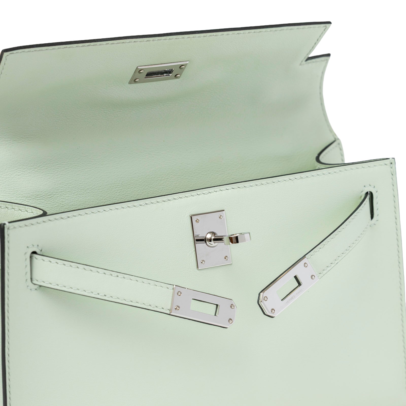 Close-up inside view of Hermès Kelly Pochette Vert Fizz Swift Palladium Hardware showing flap and lock details