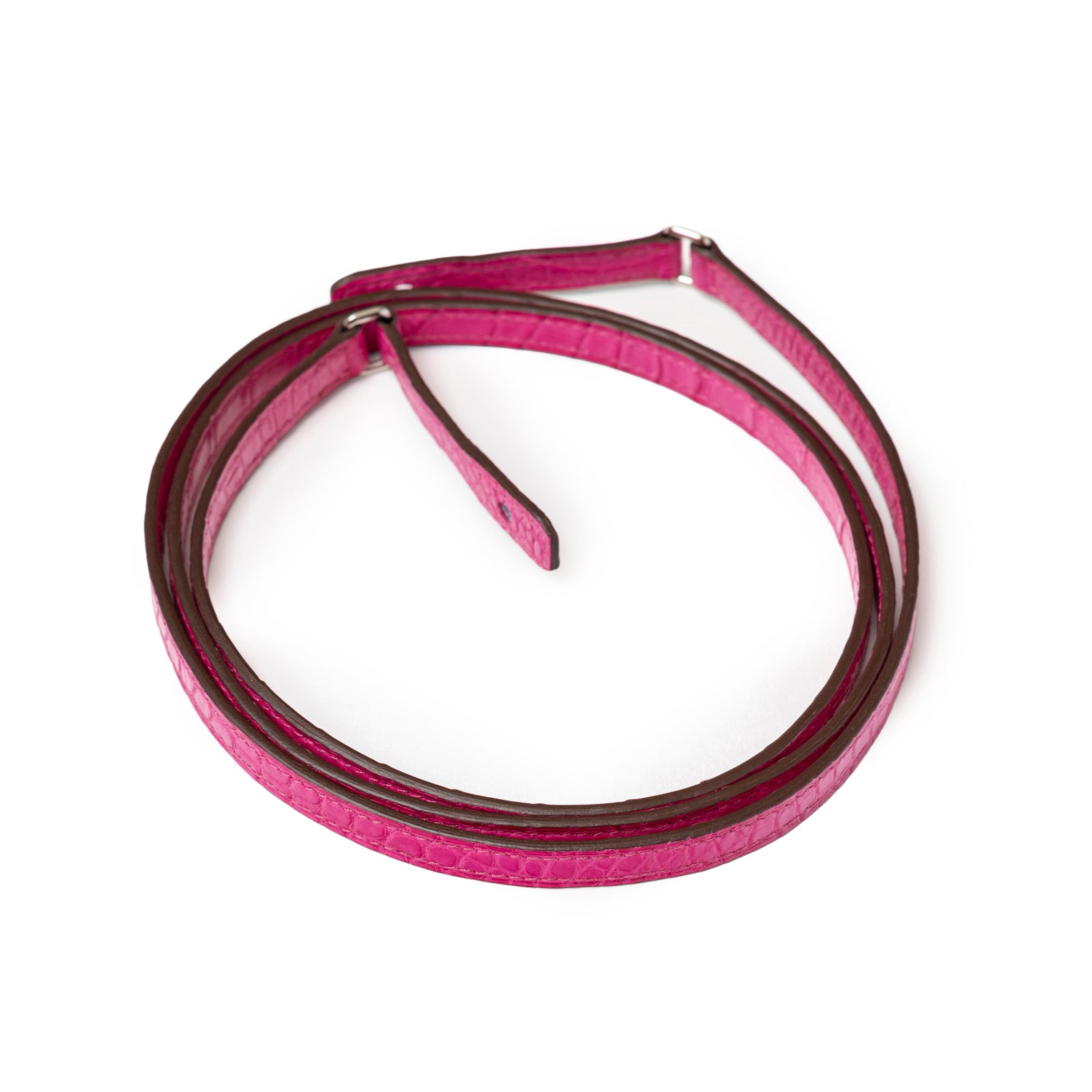 Close-up top view of Hermès Kelly Wallet To Go Rose Shocking Matte Alligator Palladium Hardware shoulder strap