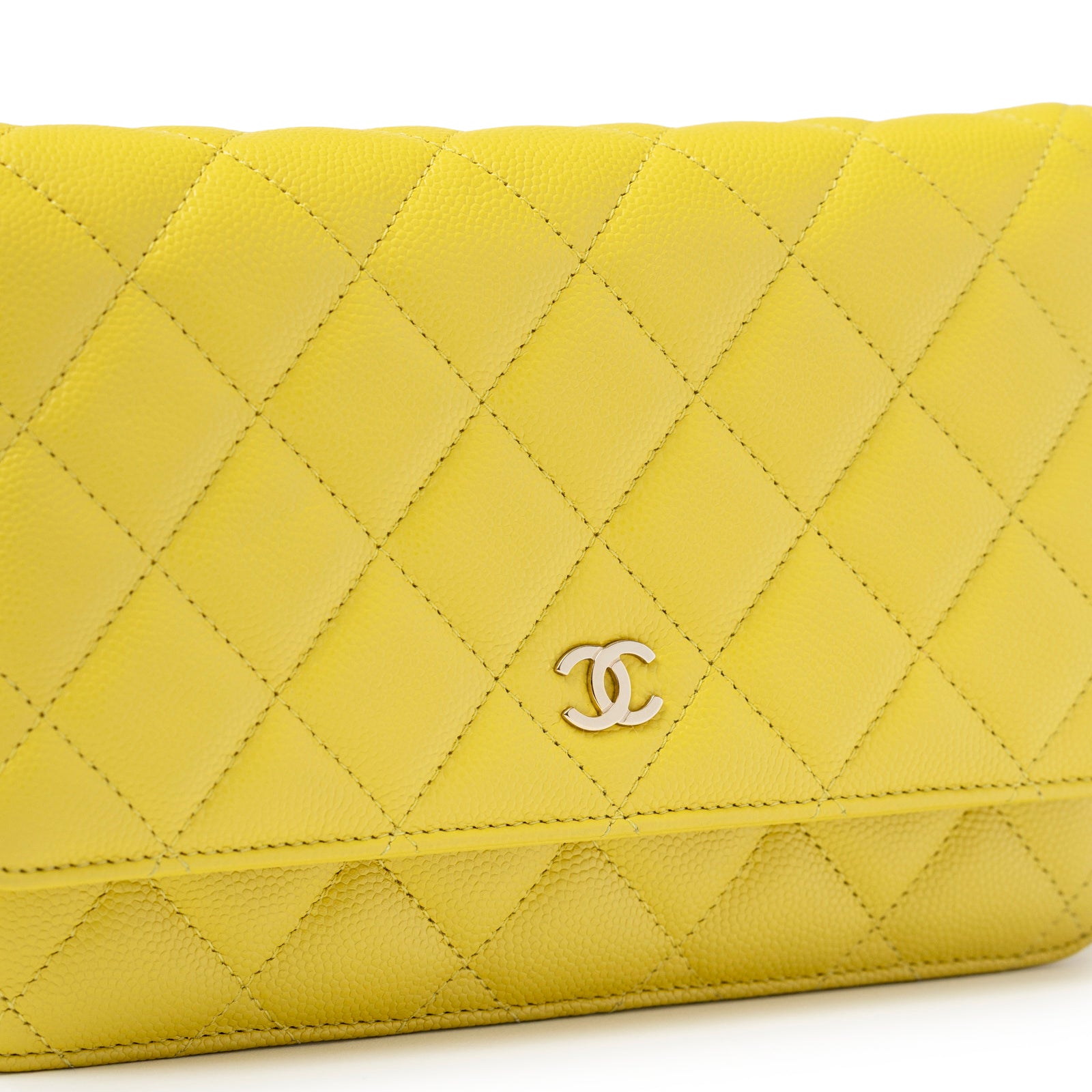 Close-up of quilted pattern and palladium hardware on Chanel Wallet On Chain Yellow Caviar Palladium Hardware