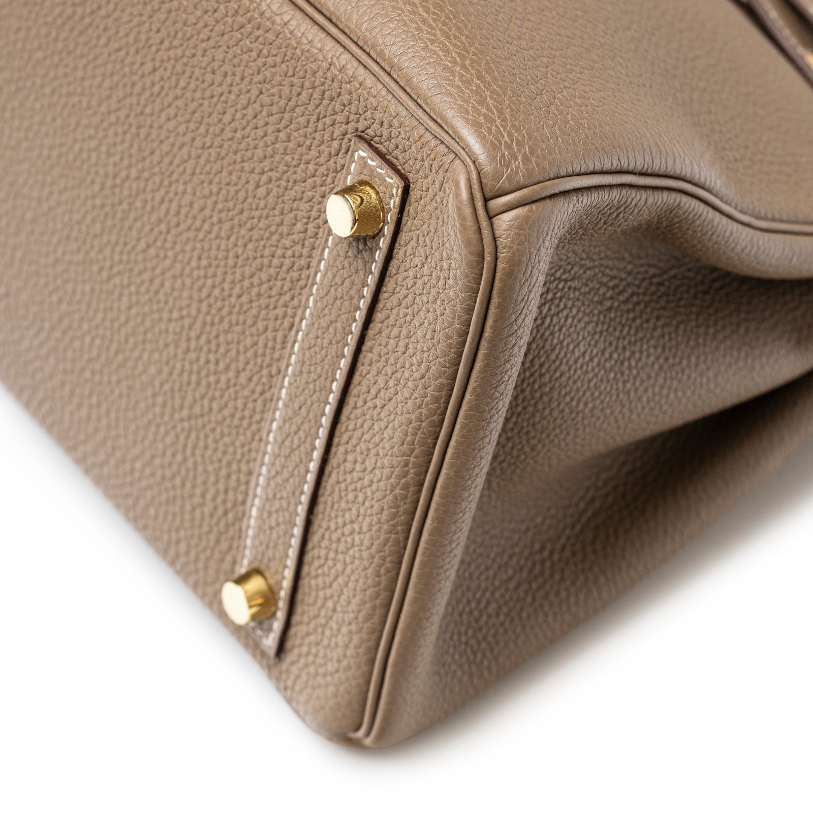 Close-up angled view of Hermès Birkin 30 Etoupe Togo Gold Hardware bottom corner with stitching and feet details